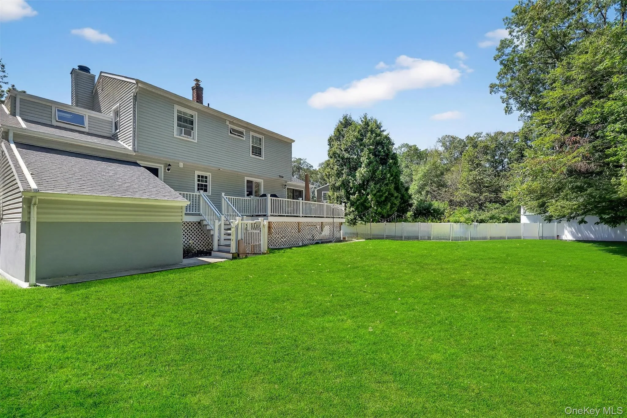 Fenced backyard with stairway and a deck Fenced backyard with stairway and a deck