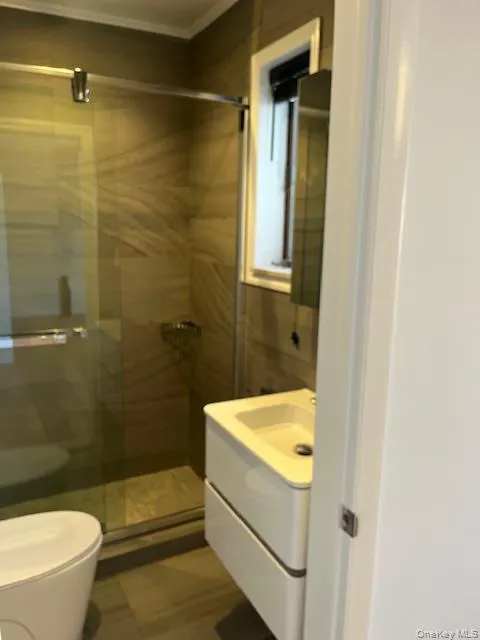 Full bathroom featuring vanity, a shower stall, and light tile patterned floors Full bathroom featuring vanity, a shower stall, and light tile patterned floors