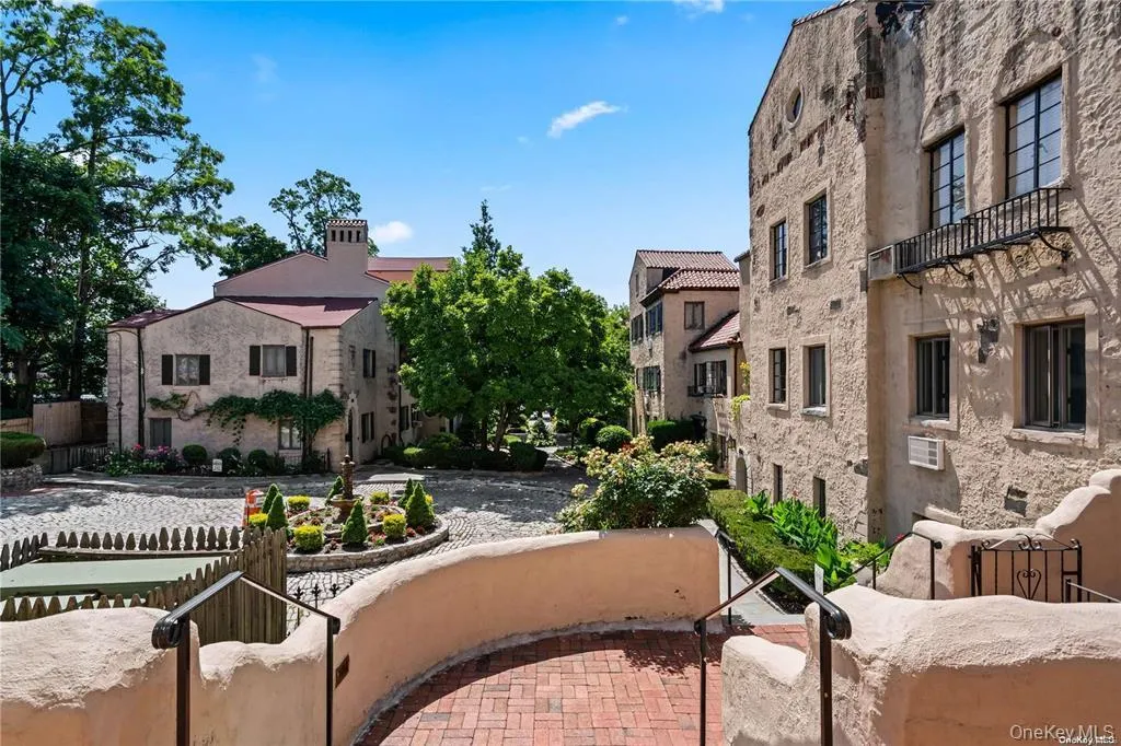 View of property's community featuring a fenced front yard, a residential view, and a patio area View of property's community featuring a fenced front yard, a residential view, and a patio area