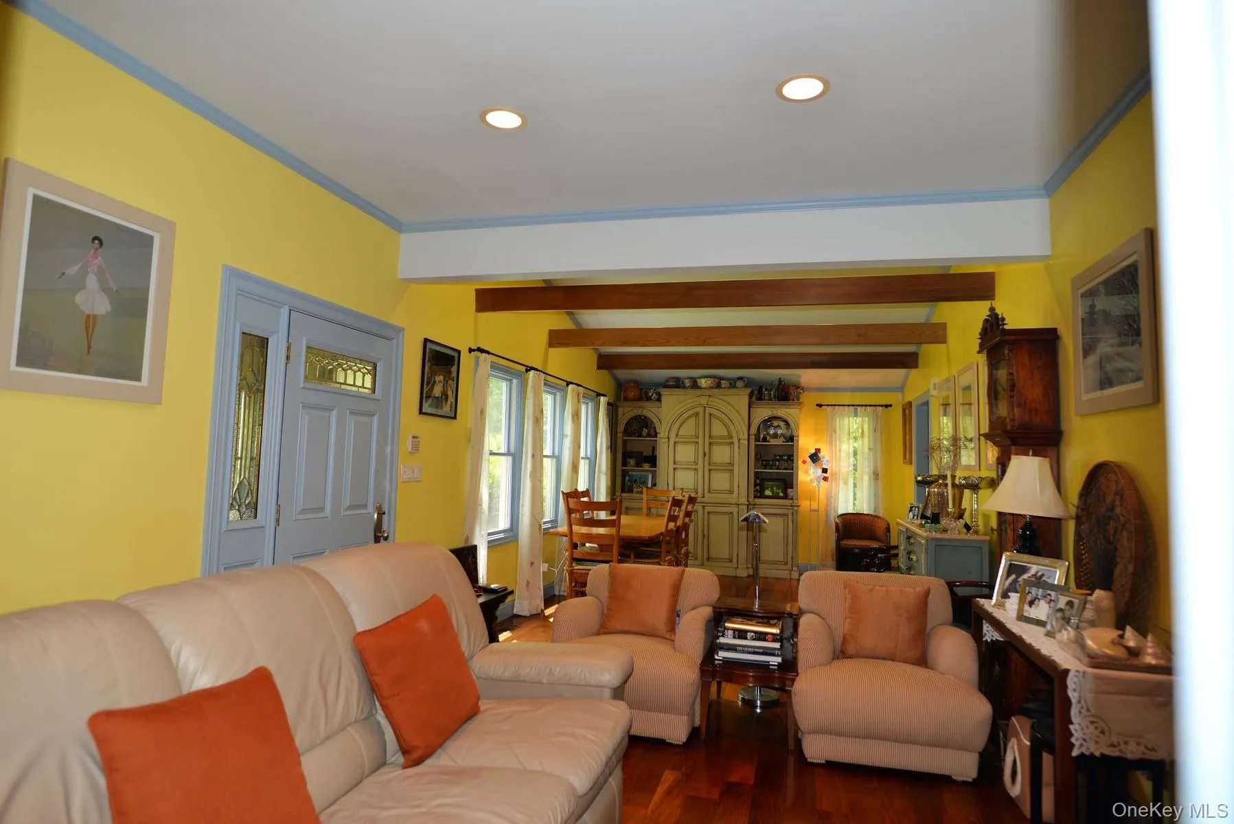 Living room featuring dark wood-style floors, recessed lighting, crown molding, and beam ceiling