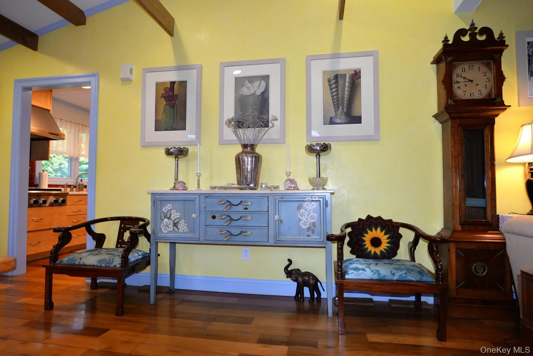 Sitting room with beamed ceiling and dark wood-style flooring