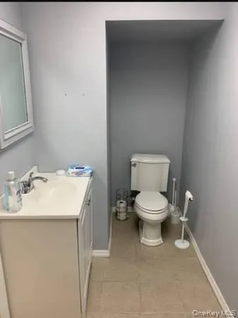 Bathroom featuring vanity and light tile patterned floors Bathroom featuring vanity and light tile patterned floors