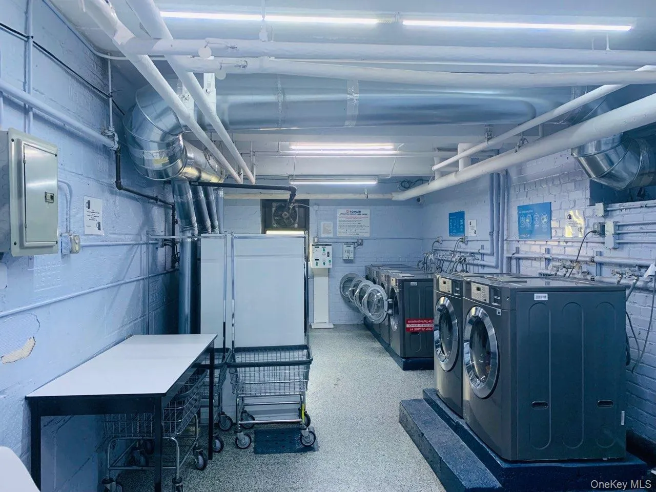 Laundry room with electric panel and independent washer and dryer Laundry room with electric panel and independent washer and dryer