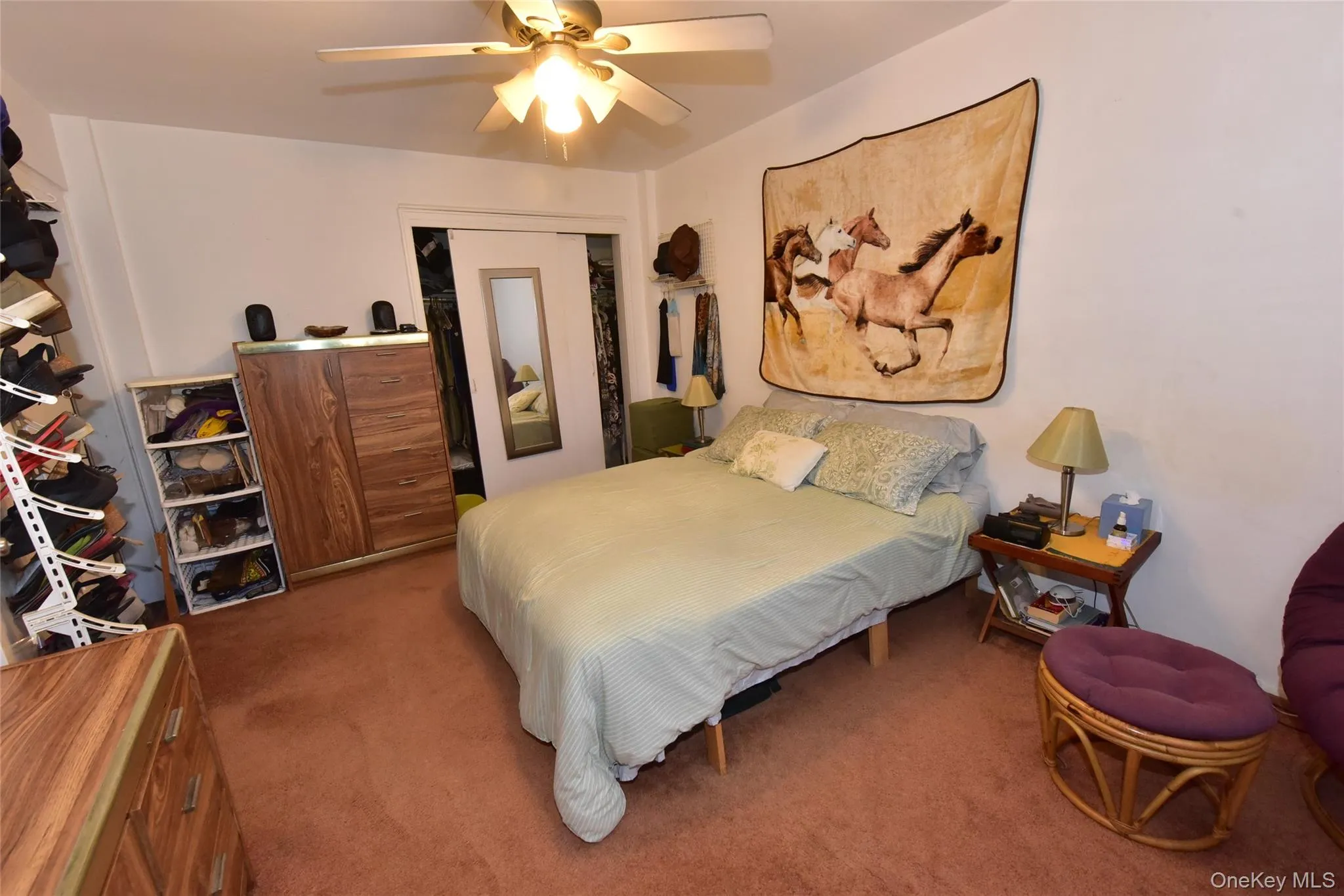 Bedroom with carpet, a ceiling fan, and a closet Bedroom with carpet, a ceiling fan, and a closet