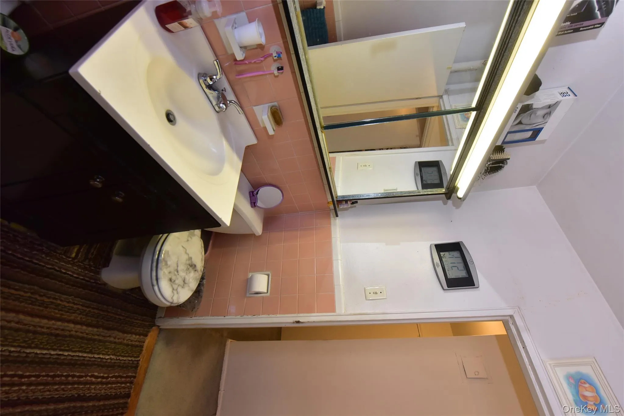 Half bathroom with vanity, tile walls, and a wainscoted wall Half bathroom with vanity, tile walls, and a wainscoted wall