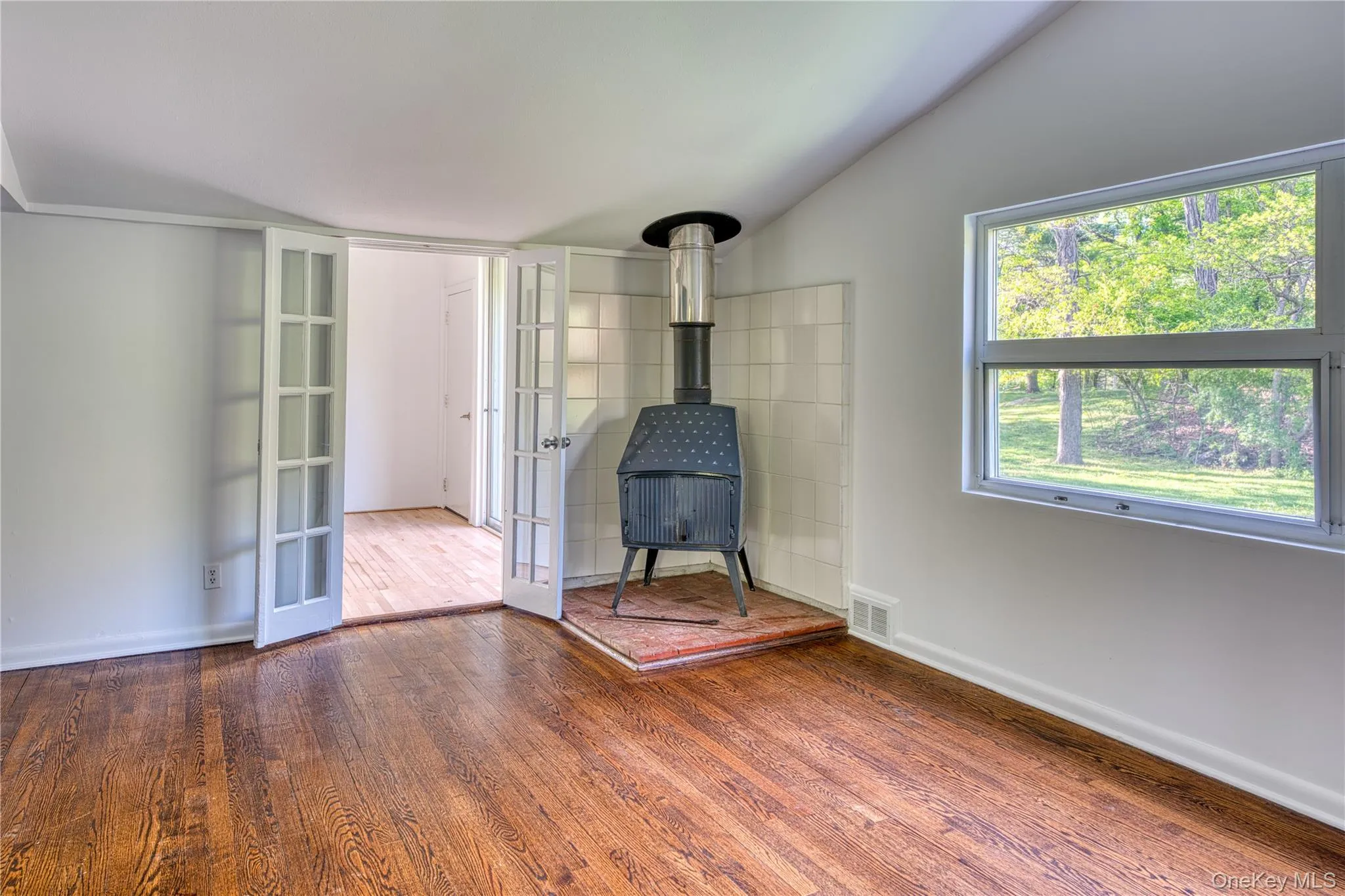 Wood Burning Stove with doorway to the foyer hall way. Wood Burning Stove with doorway to the foyer hall way.