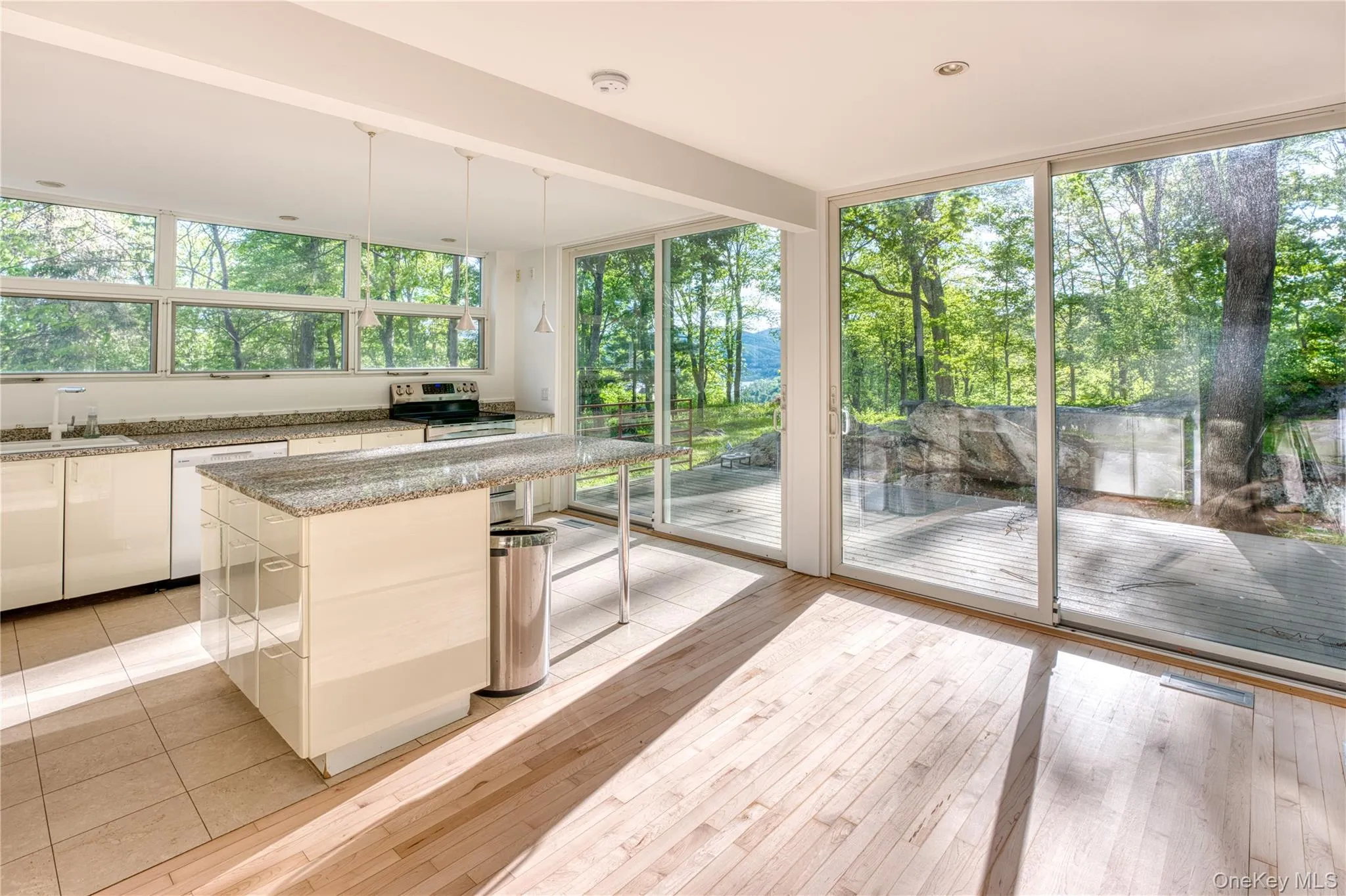 Kitchen with Granite Countertop Island, Granite countertop Cabinets, Convection Stove, Sliding Glass doors to deck, Refinished Hardwood Floors Kitchen with Granite Countertop Island, Granite countertop Cabinets, Convection Stove, Sliding Glass doors to deck, Refinished Hardwood Floors