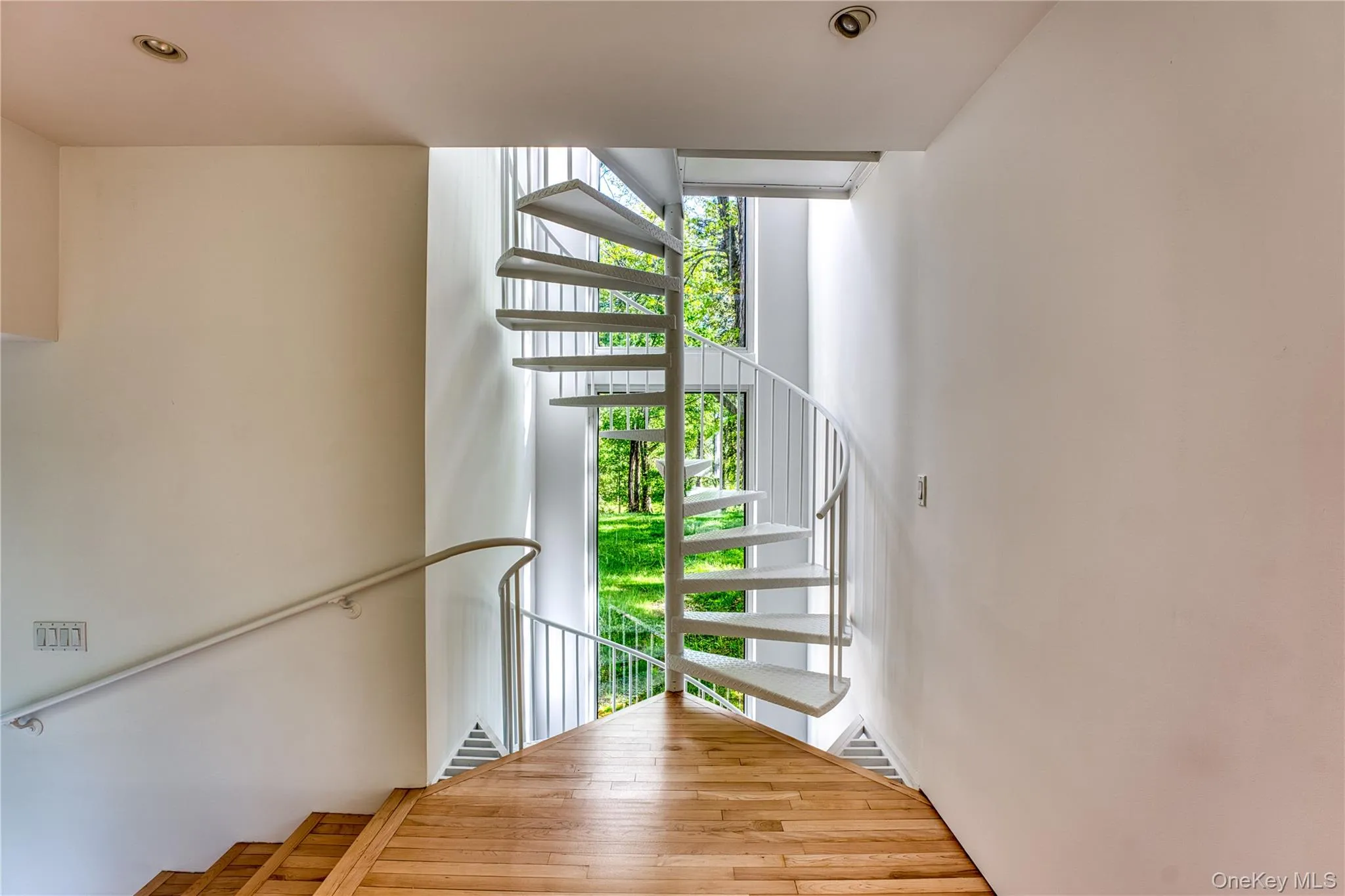 Spiral stairs to Primary BR and stairs to left to Entry Foyer Hallway Spiral stairs to Primary BR and stairs to left to Entry Foyer Hallway