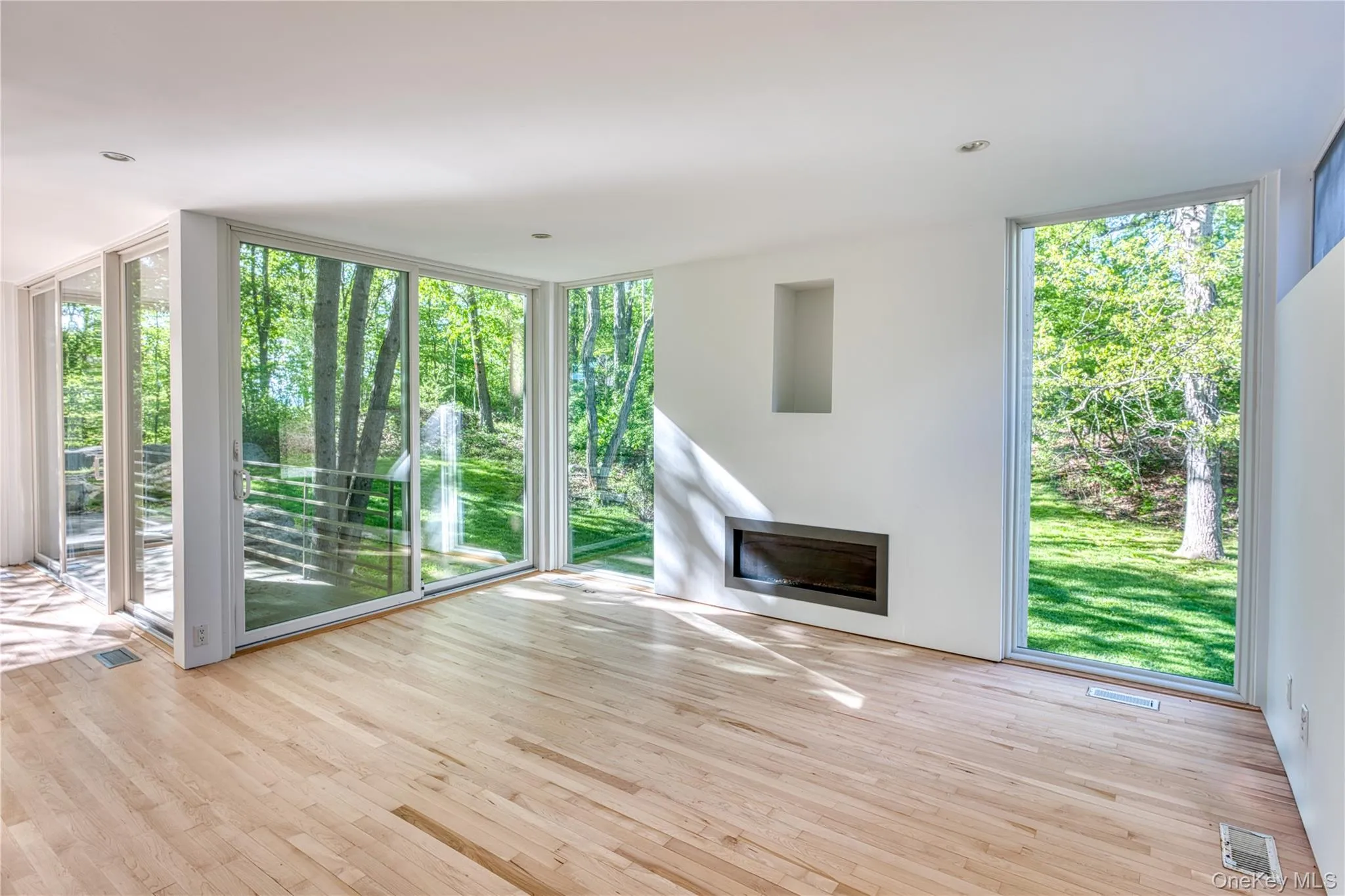 LR with Fireplace, Wall to Ceiling Glass windows, Sliding Glass Doors to deck, entrance on left to Kitchen LR with Fireplace, Wall to Ceiling Glass windows, Sliding Glass Doors to deck, entrance on left to Kitchen