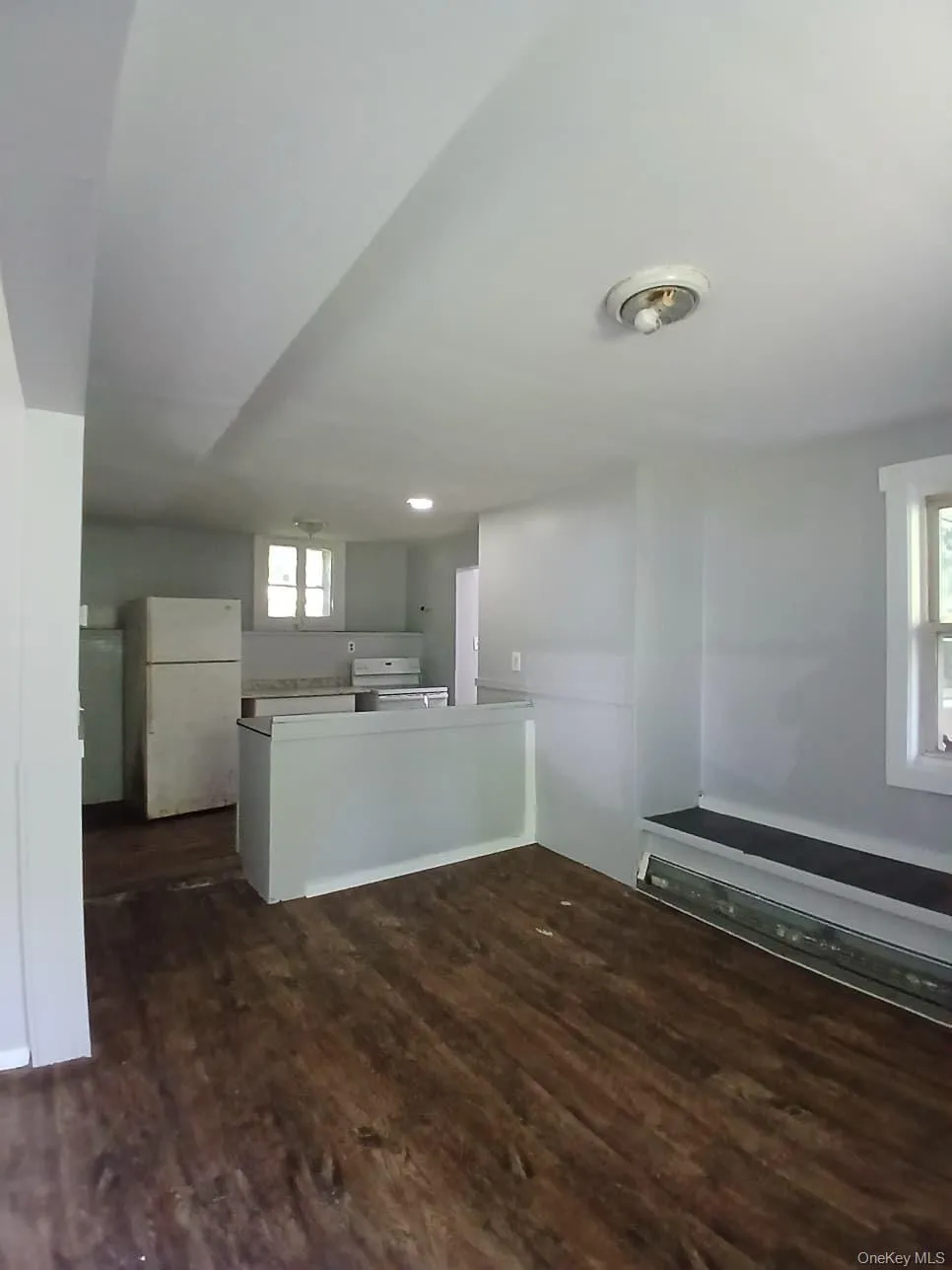 Unfurnished living room with dark wood-type flooring Unfurnished living room with dark wood-type flooring