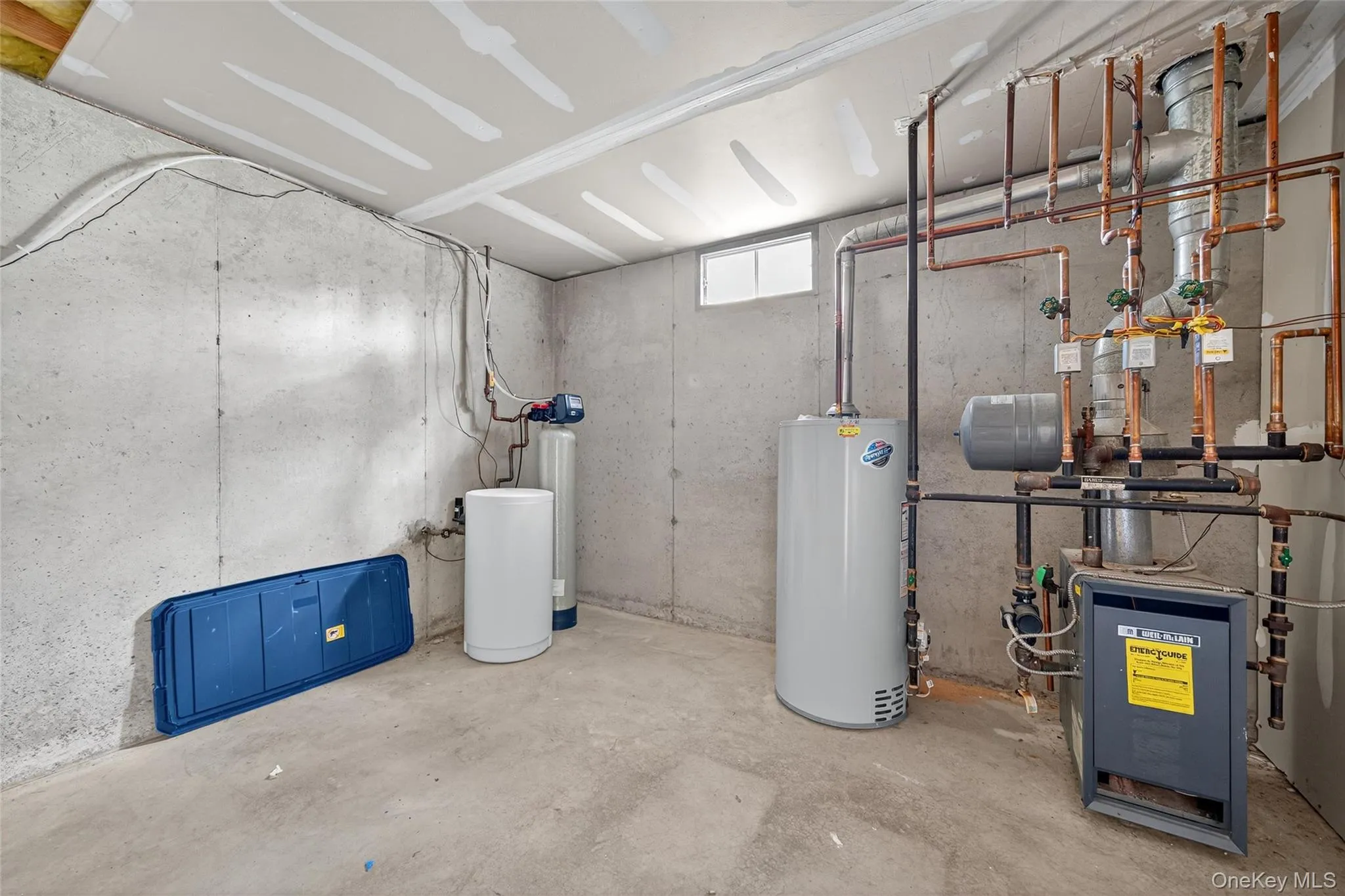 Utility room with gas water heater and a heating unit Utility room with gas water heater and a heating unit
