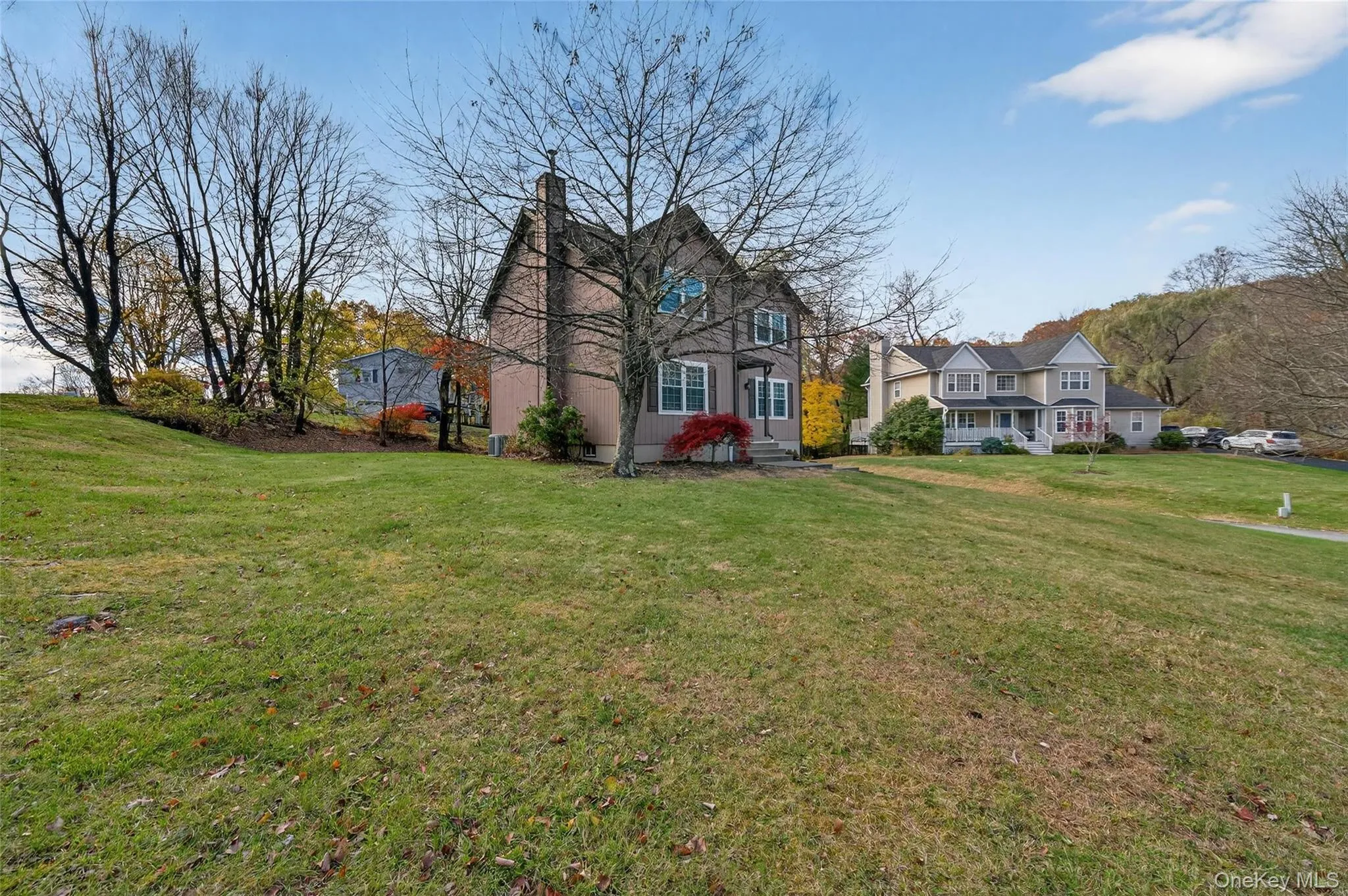 View of front facade with a front yard and a chimney View of front facade with a front yard and a chimney