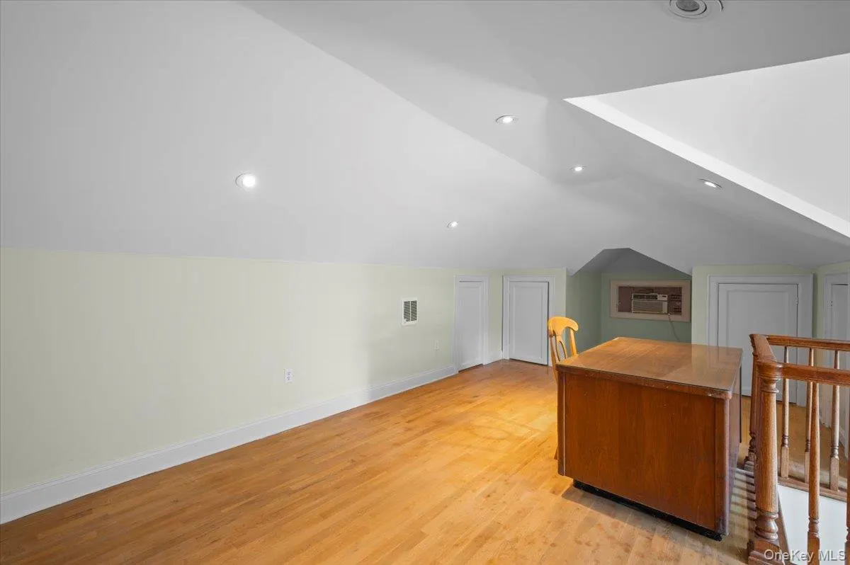 Additional living space with lofted ceiling, light wood finished floors, and recessed lighting Additional living space with lofted ceiling, light wood finished floors, and recessed lighting