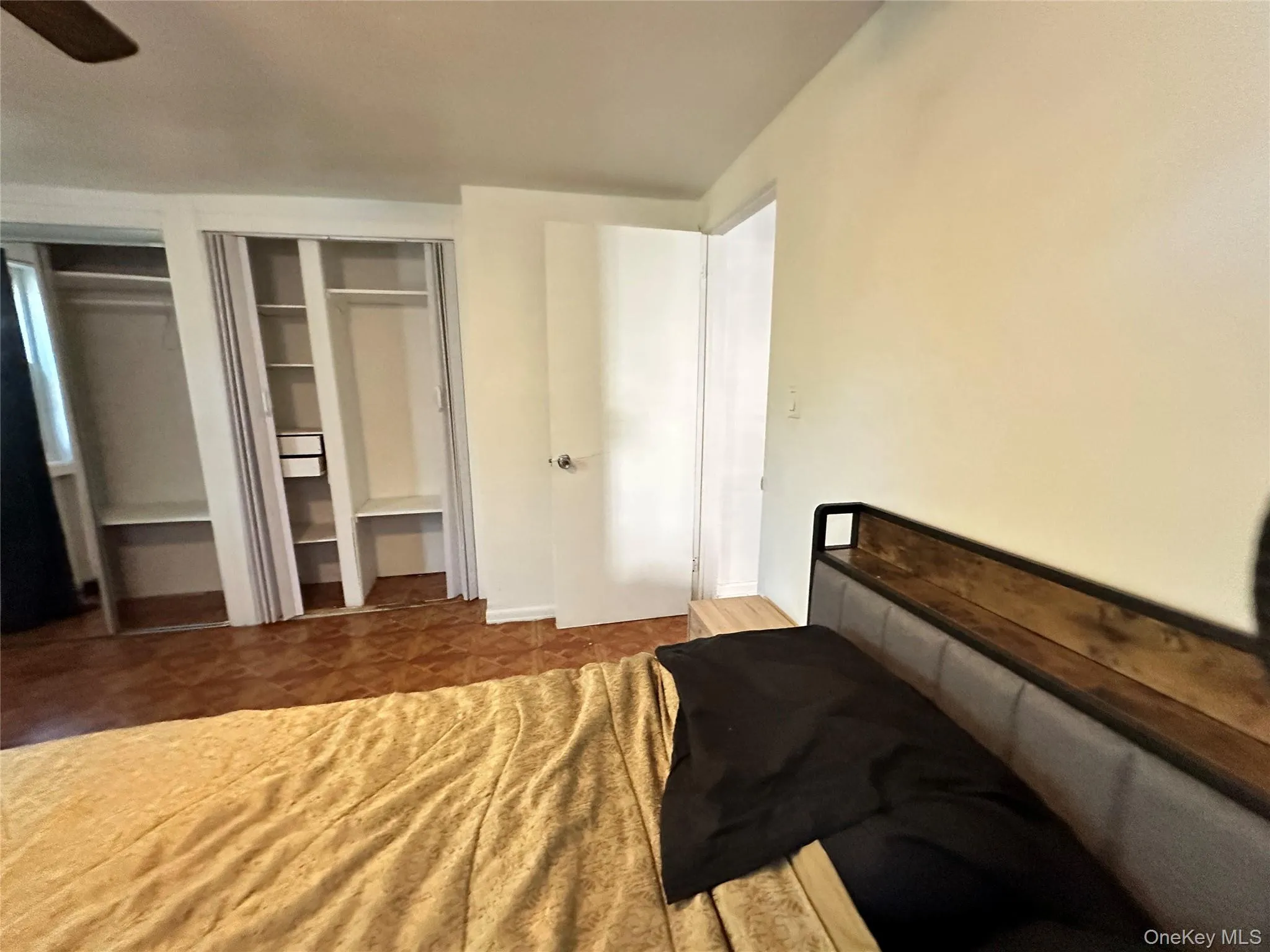 Bedroom featuring multiple closets and a ceiling fan Bedroom featuring multiple closets and a ceiling fan