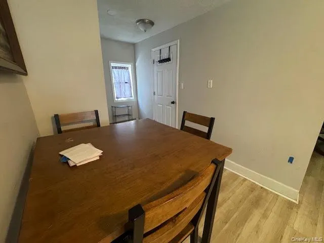 Dining area with baseboards and light wood-style flooring Dining area with baseboards and light wood-style flooring