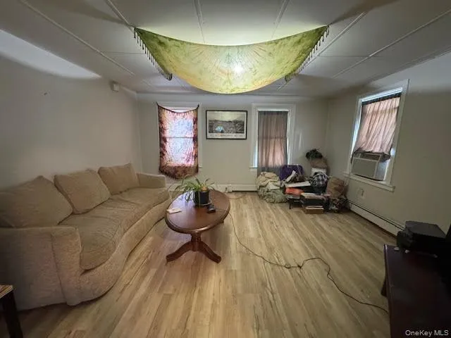 Living area with light wood finished floors and baseboards Living area with light wood finished floors and baseboards