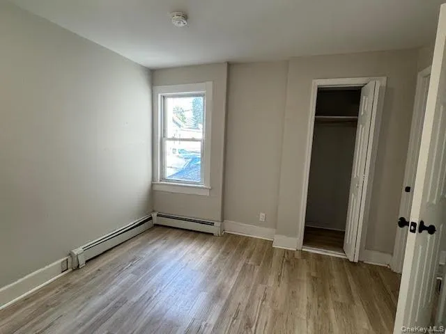 Unfurnished bedroom featuring light wood-style floors and a closet Unfurnished bedroom featuring light wood-style floors and a closet