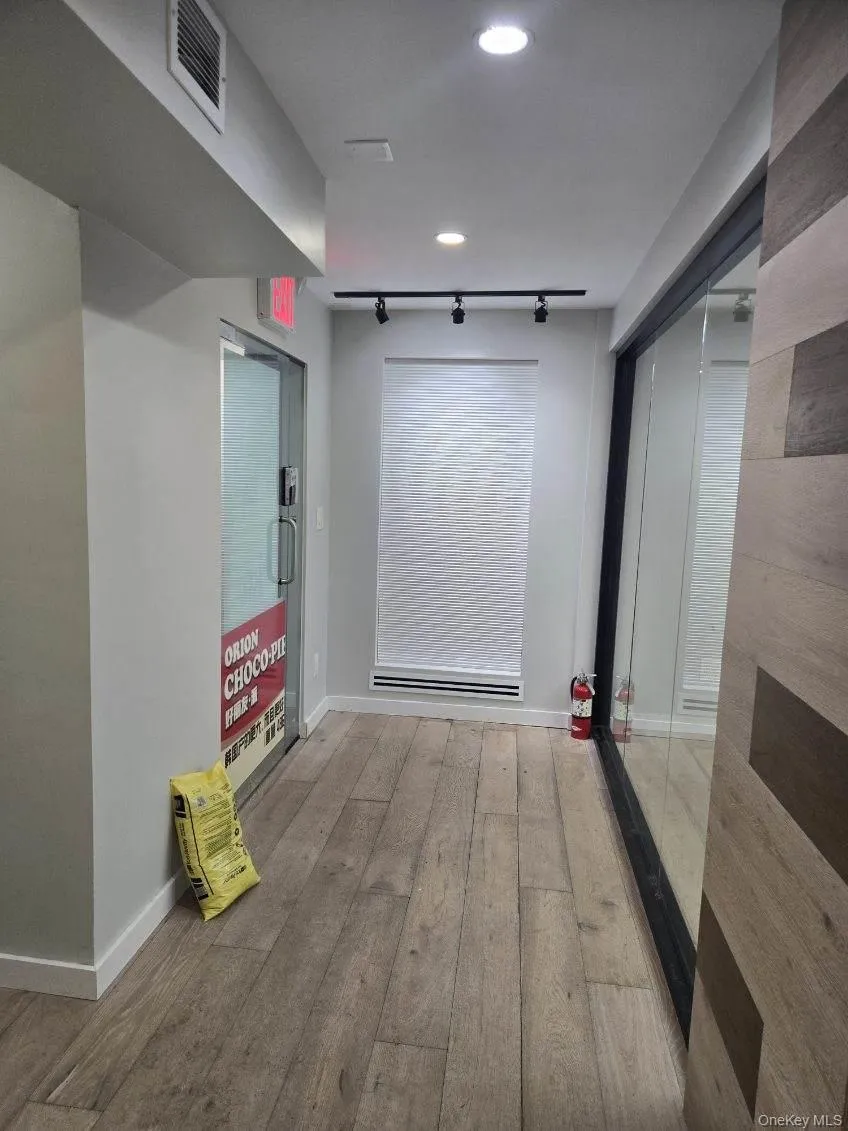 Hallway with wood finished floors and rail lighting Hallway with wood finished floors and rail lighting