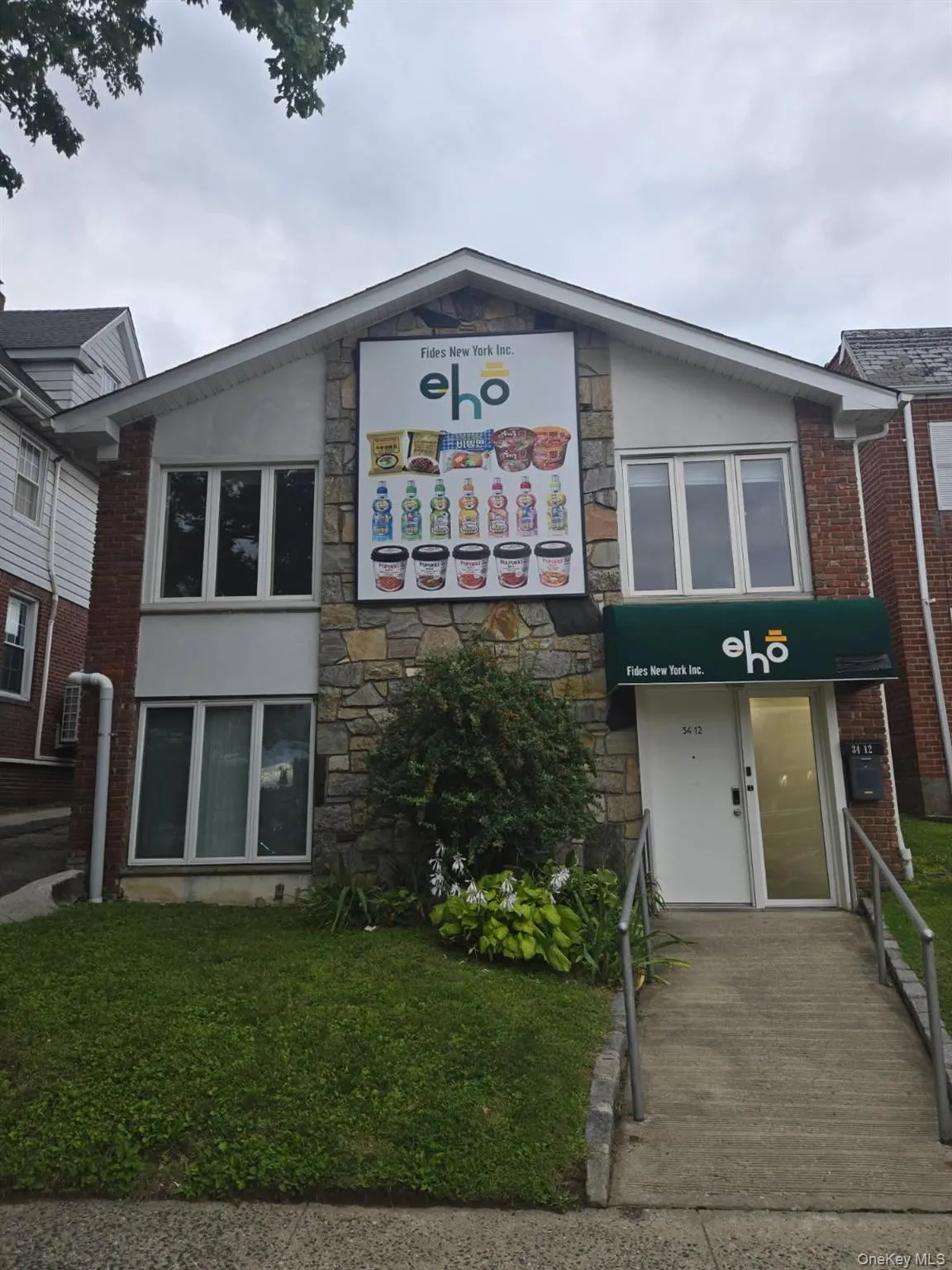 View of front of home featuring stone siding and stucco siding View of front of home featuring stone siding and stucco siding