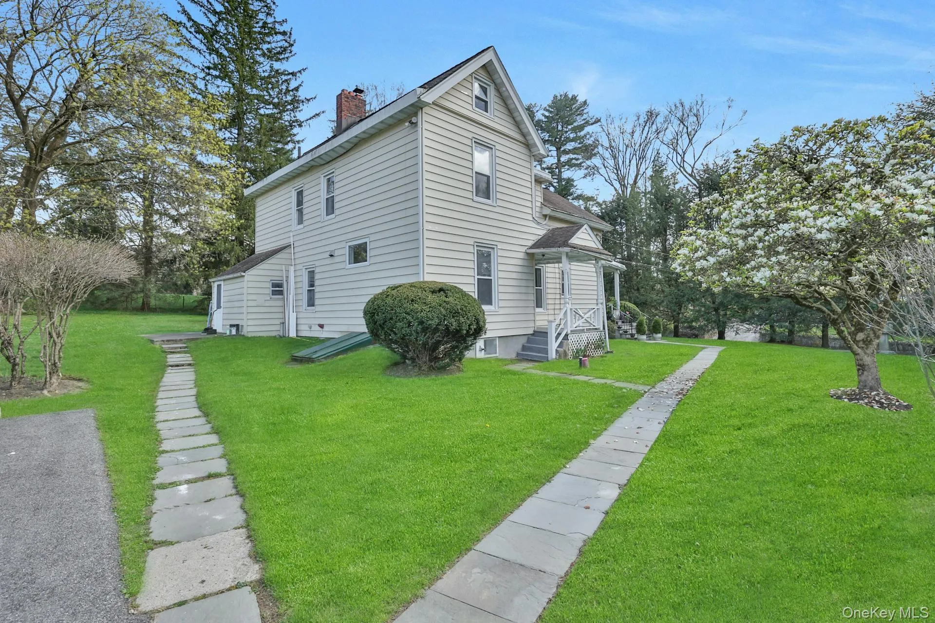 View of side of property with a chimney and a yard View of side of property with a chimney and a yard