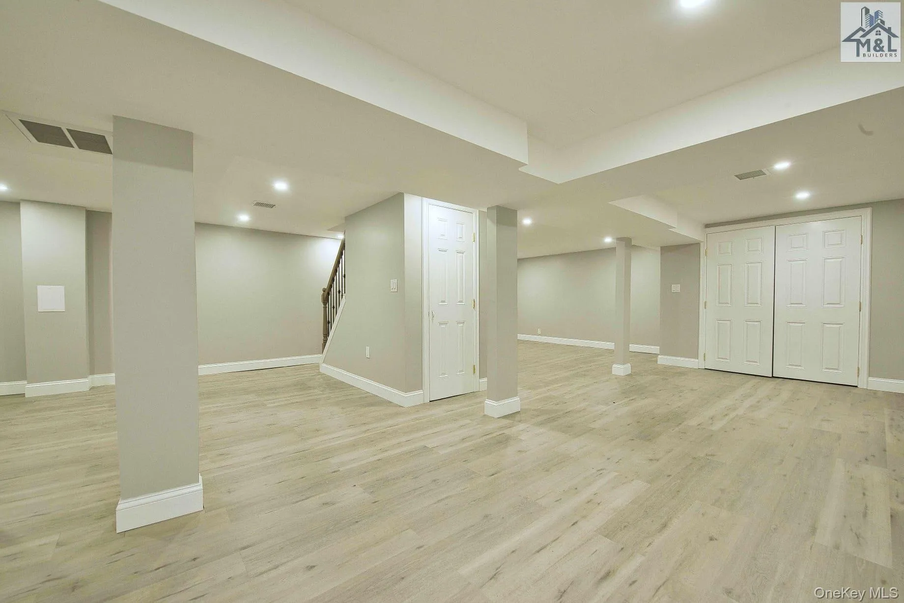 Finished below grade area featuring stairway, light wood-style floors, and recessed lighting Finished below grade area featuring stairway, light wood-style floors, and recessed lighting