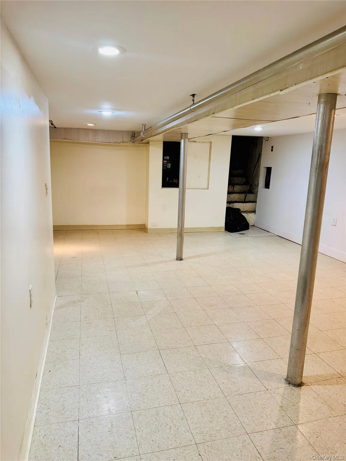 Finished basement with stairs and recessed lighting Finished basement with stairs and recessed lighting