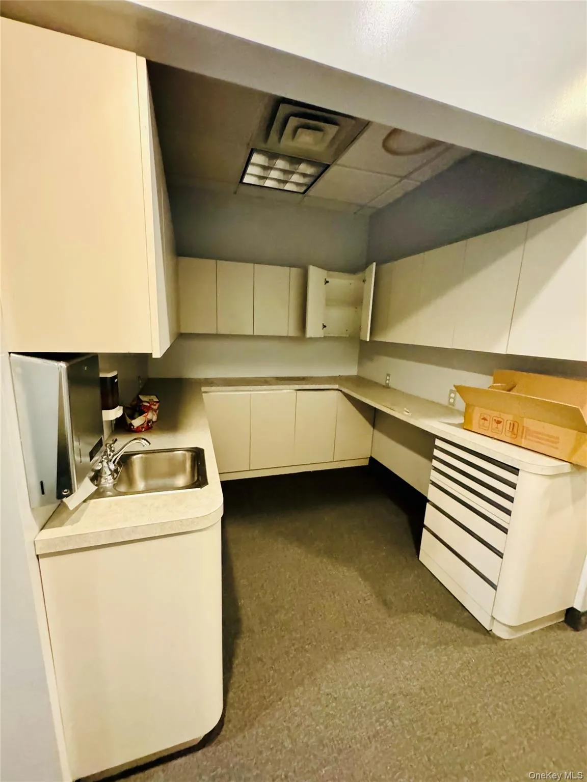 Kitchen featuring light countertops and a sink Kitchen featuring light countertops and a sink