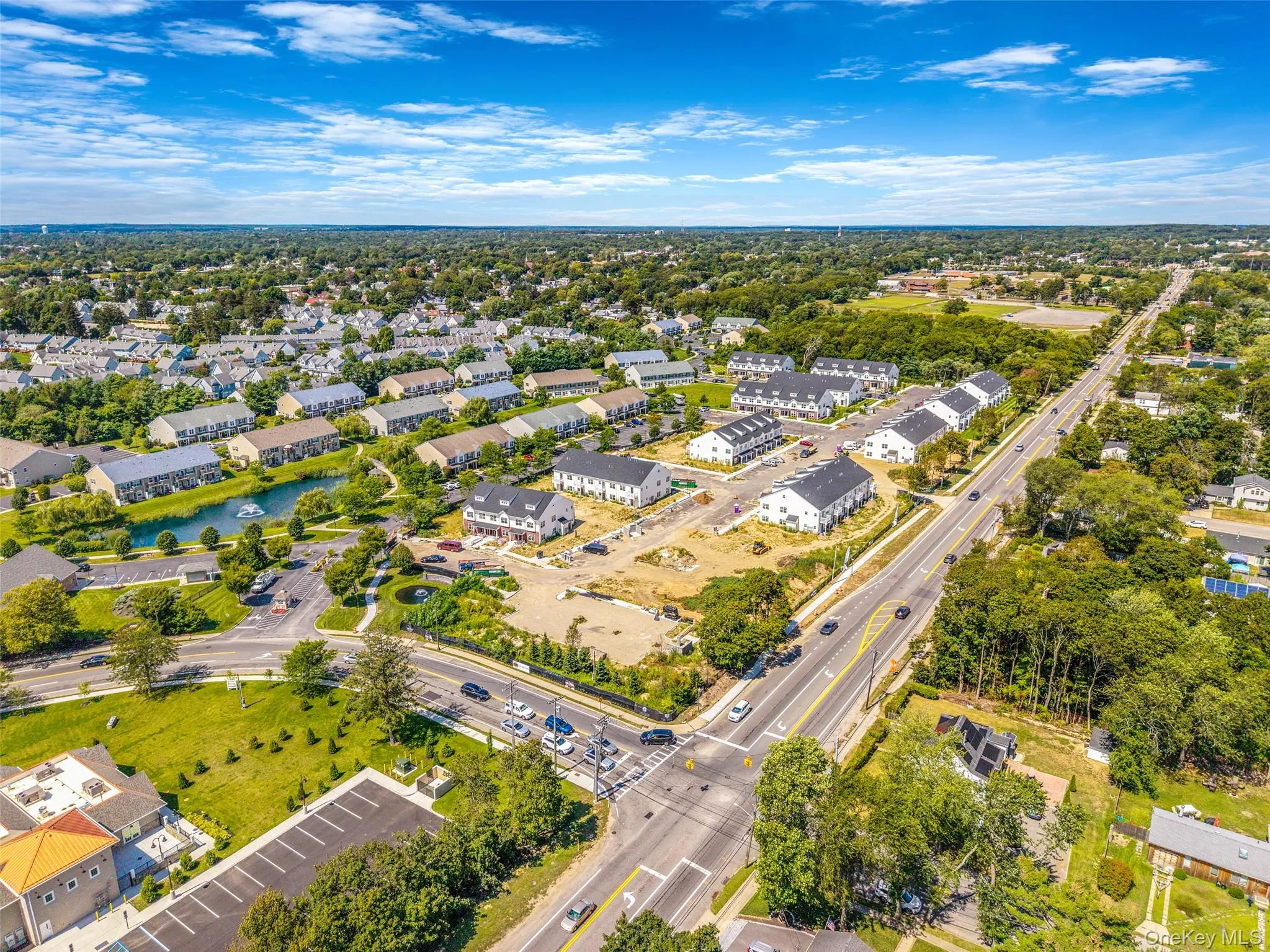 Aerial view of a nearby body of water and a tree filled landscape Aerial view of a nearby body of water and a tree filled landscape