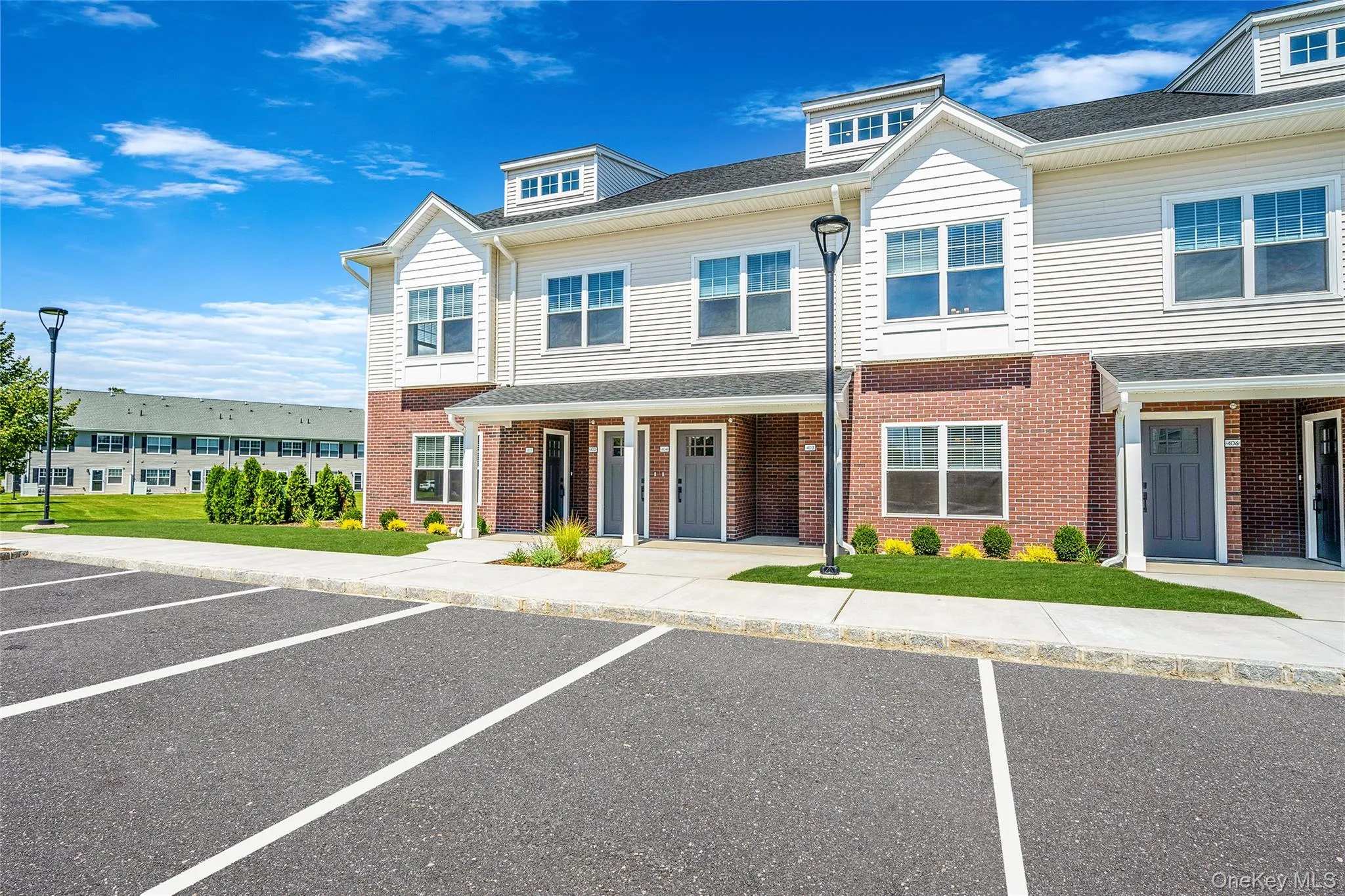 View of front of house featuring uncovered parking and brick siding View of front of house featuring uncovered parking and brick siding