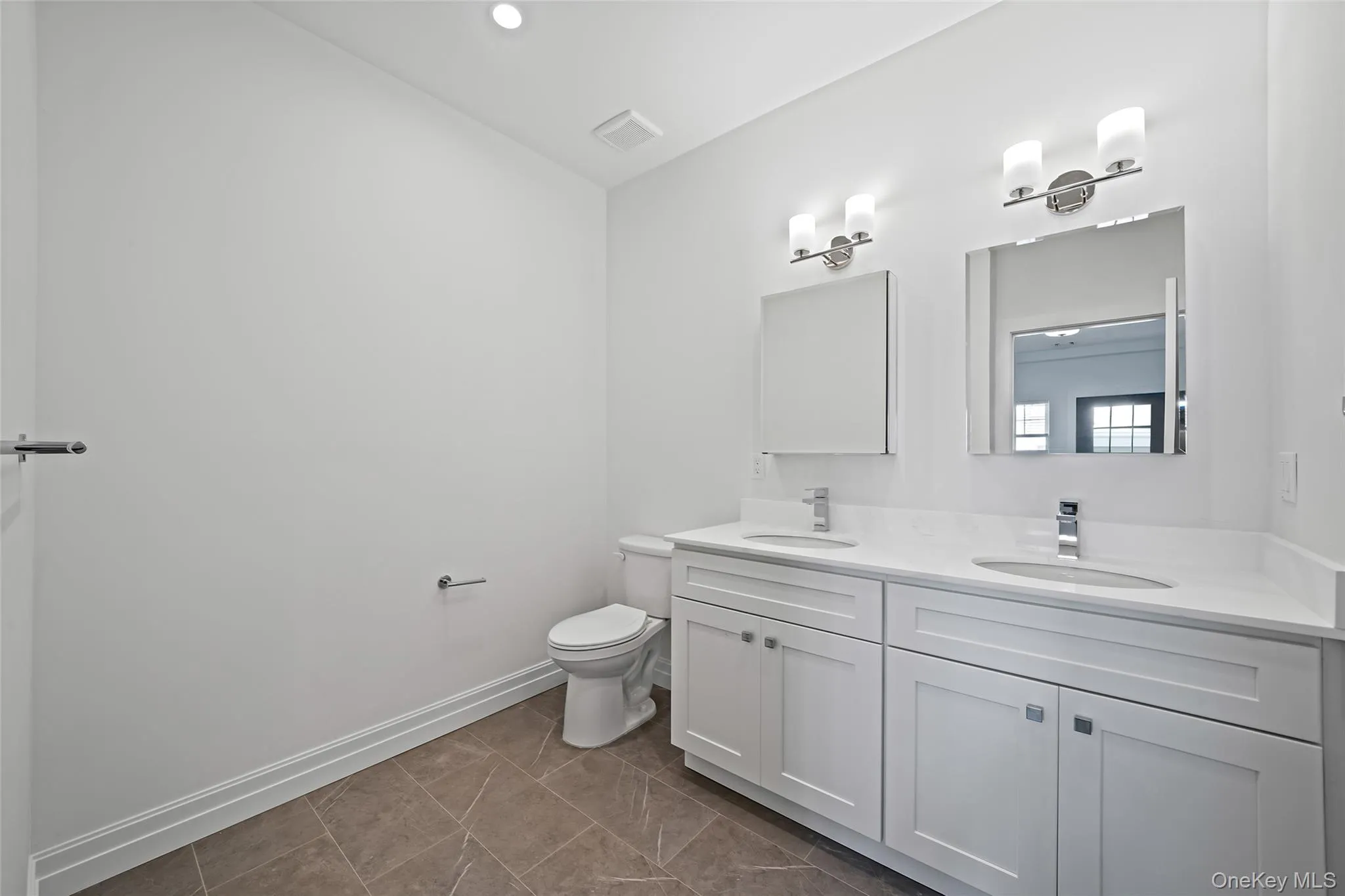 Full bathroom with double vanity, dark tile patterned floors, and recessed lighting Full bathroom with double vanity, dark tile patterned floors, and recessed lighting