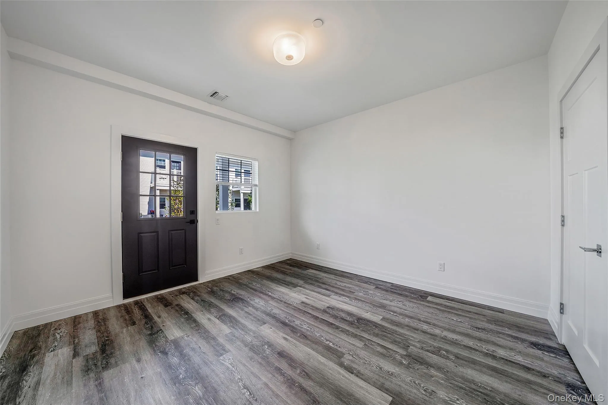 Entryway with dark wood finished floors and baseboards Entryway with dark wood finished floors and baseboards