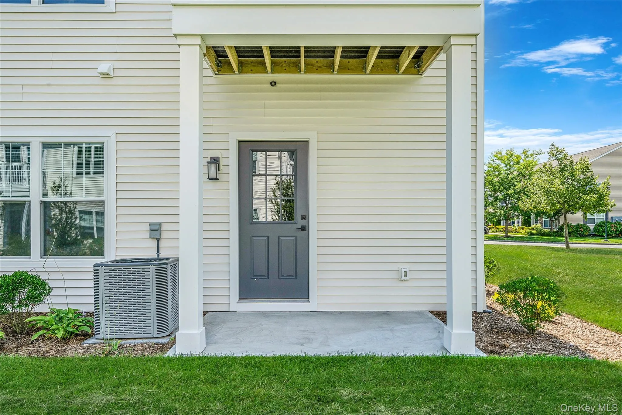 View of exterior entry featuring a yard and a patio View of exterior entry featuring a yard and a patio