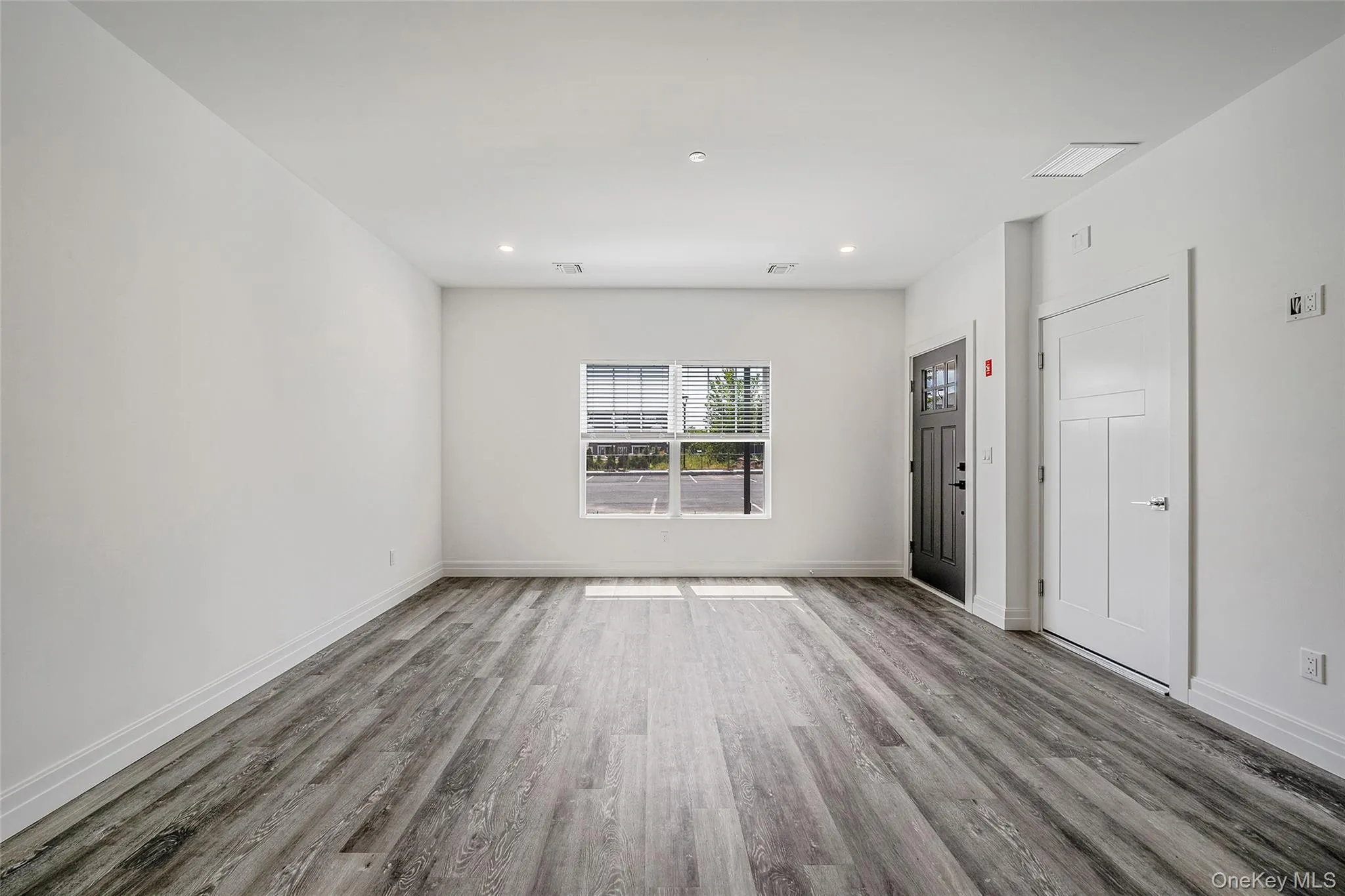 Unfurnished room with wood finished floors and recessed lighting Unfurnished room with wood finished floors and recessed lighting