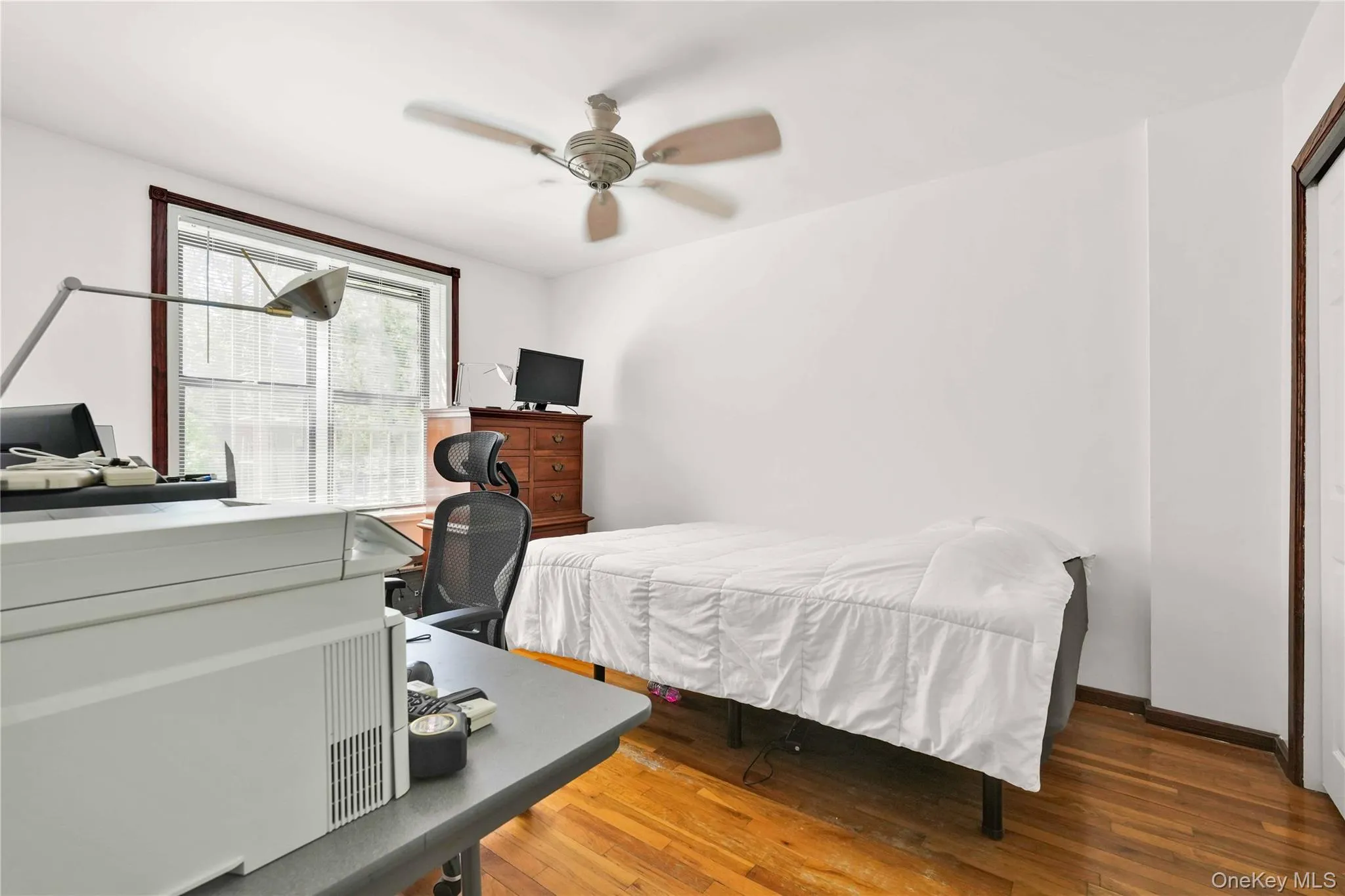 Bedroom with hardwood / wood-style flooring and a ceiling fan Bedroom with hardwood / wood-style flooring and a ceiling fan