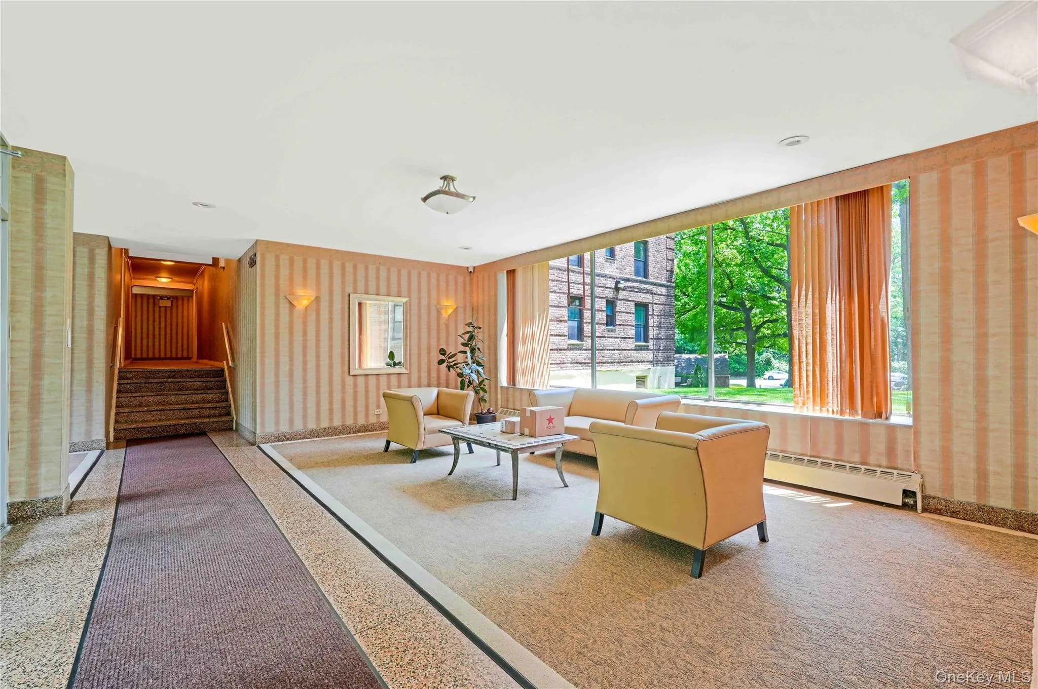 Community lobby with wallpapered walls and stairway Community lobby with wallpapered walls and stairway