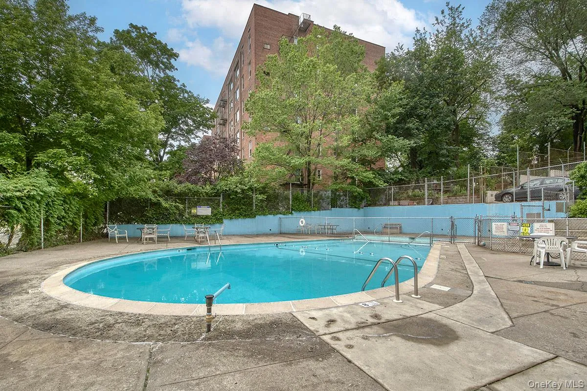 Community pool with a patio area Community pool with a patio area