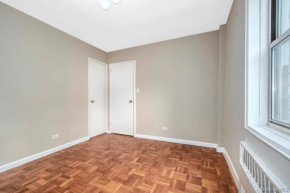 Spare room featuring radiator and baseboards Spare room featuring radiator and baseboards