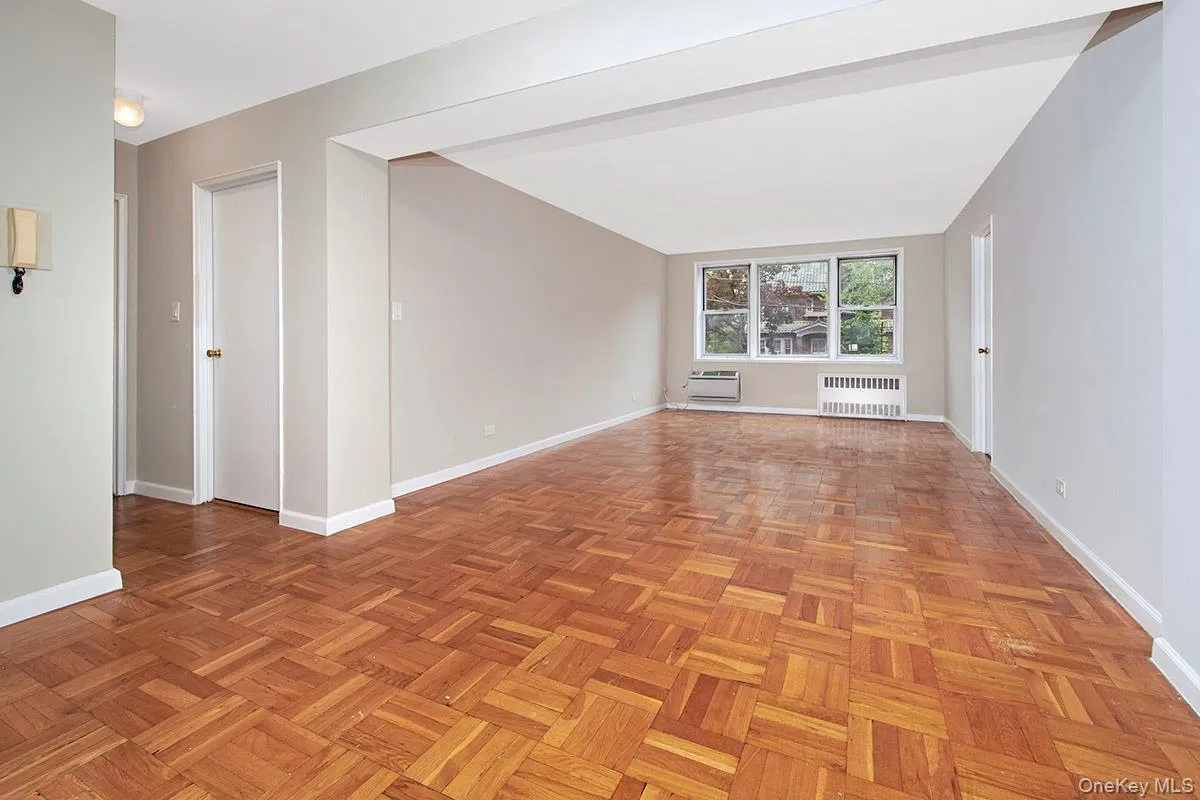 Unfurnished room featuring baseboards and radiator Unfurnished room featuring baseboards and radiator