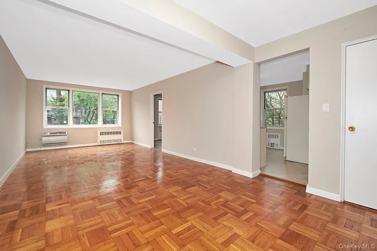 Unfurnished room with radiator heating unit and beamed ceiling Unfurnished room with radiator heating unit and beamed ceiling