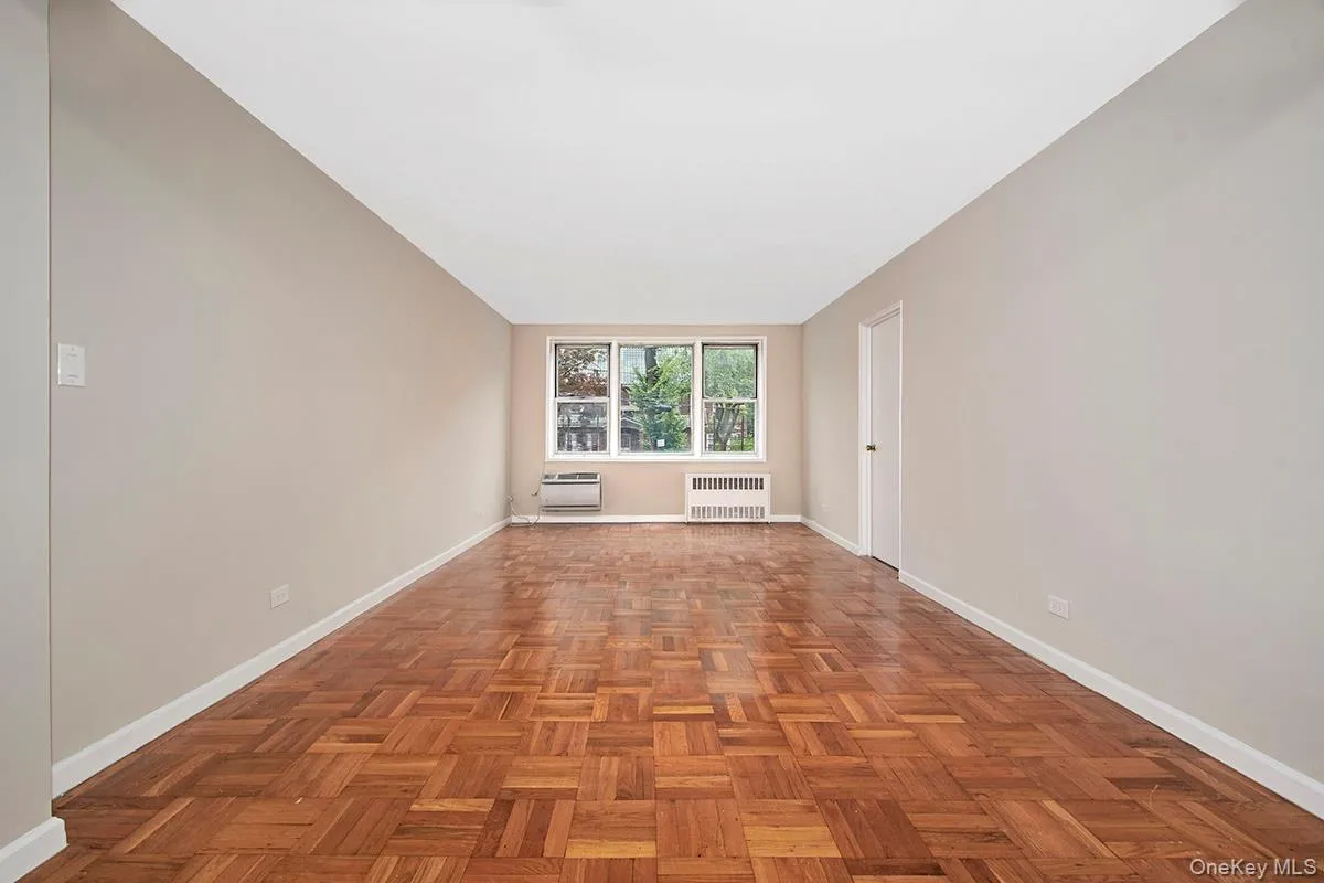 Unfurnished room featuring baseboards and radiator Unfurnished room featuring baseboards and radiator