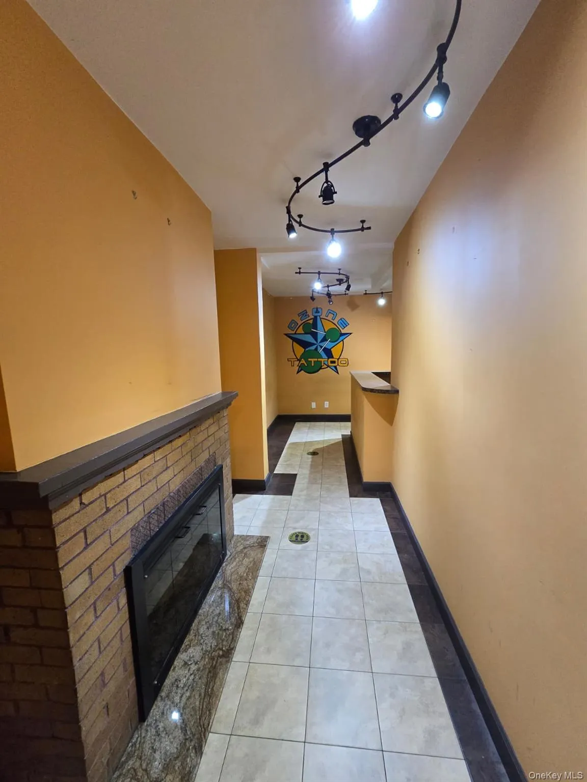Corridor with light tile patterned floors and track lighting Corridor with light tile patterned floors and track lighting