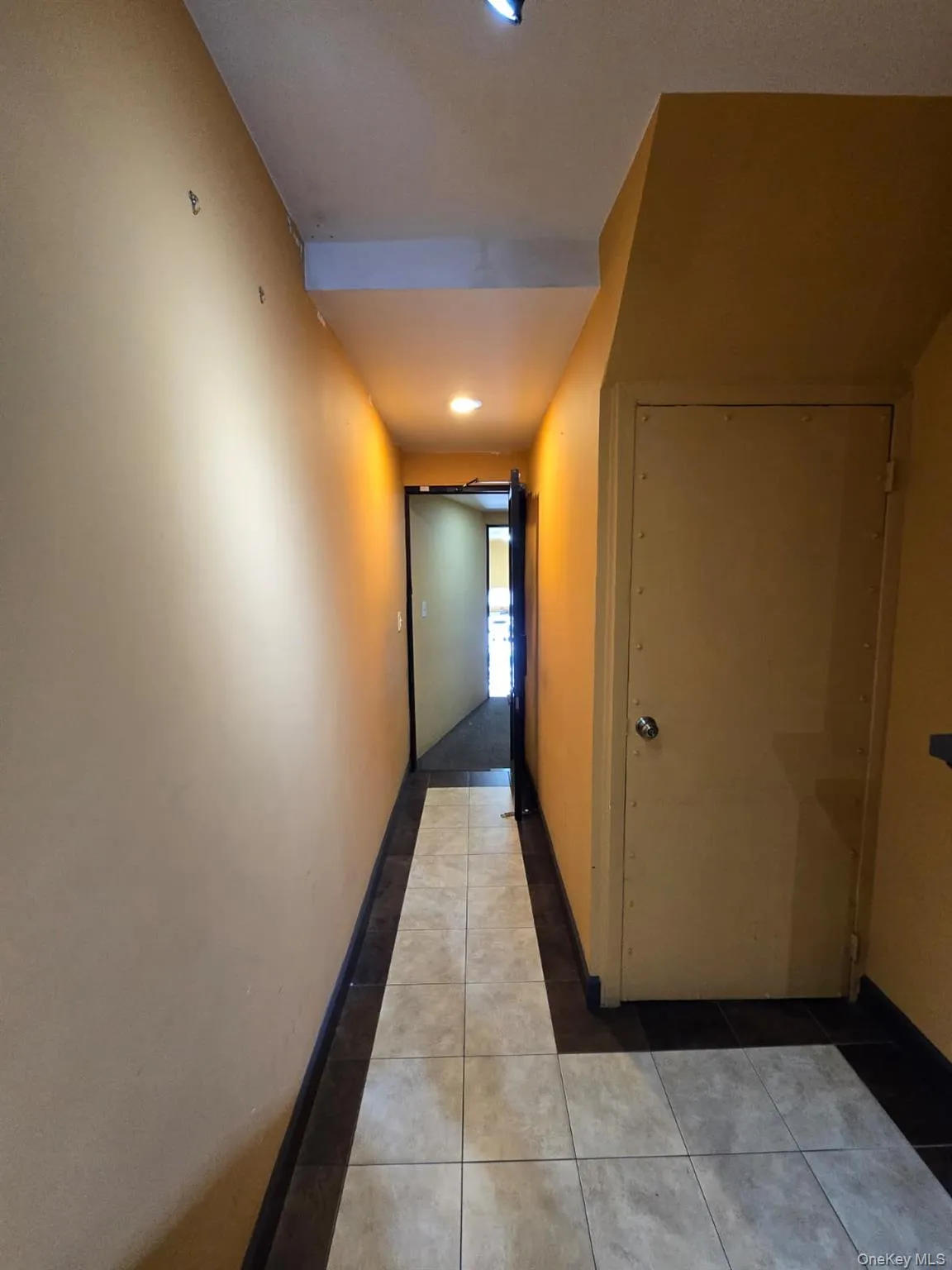 Hallway featuring tile patterned floors and recessed lighting Hallway featuring tile patterned floors and recessed lighting