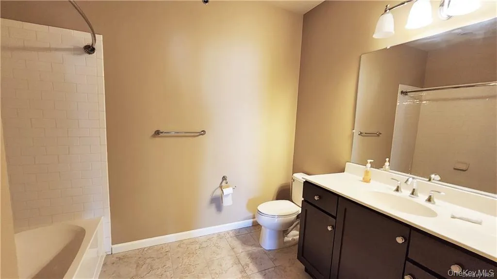Full bath featuring vanity, shower / washtub combination, and light tile patterned floors Full bath featuring vanity, shower / washtub combination, and light tile patterned floors