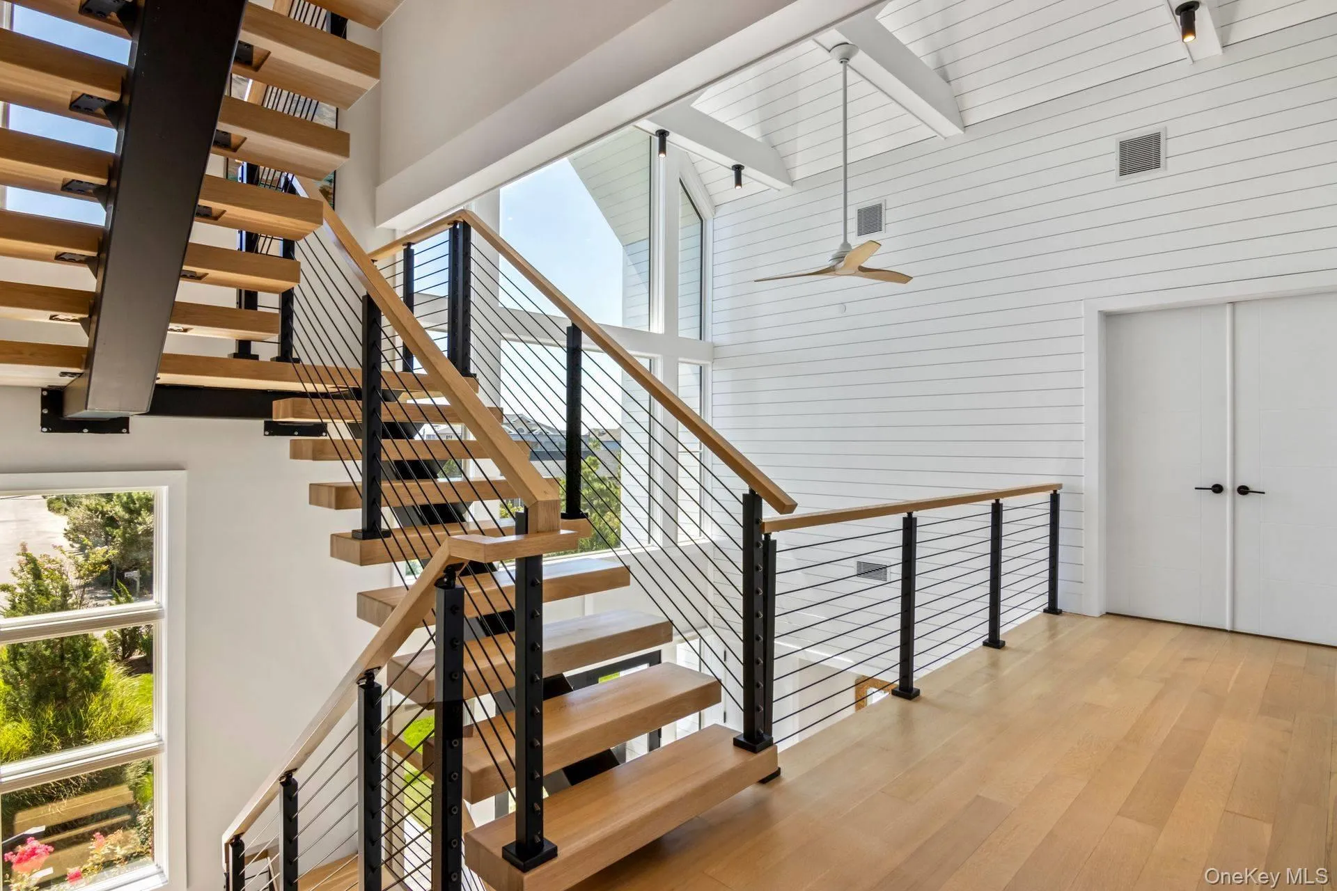 Second Level Stairway featuring a towering ceiling, wood floors Second Level Stairway featuring a towering ceiling, wood floors