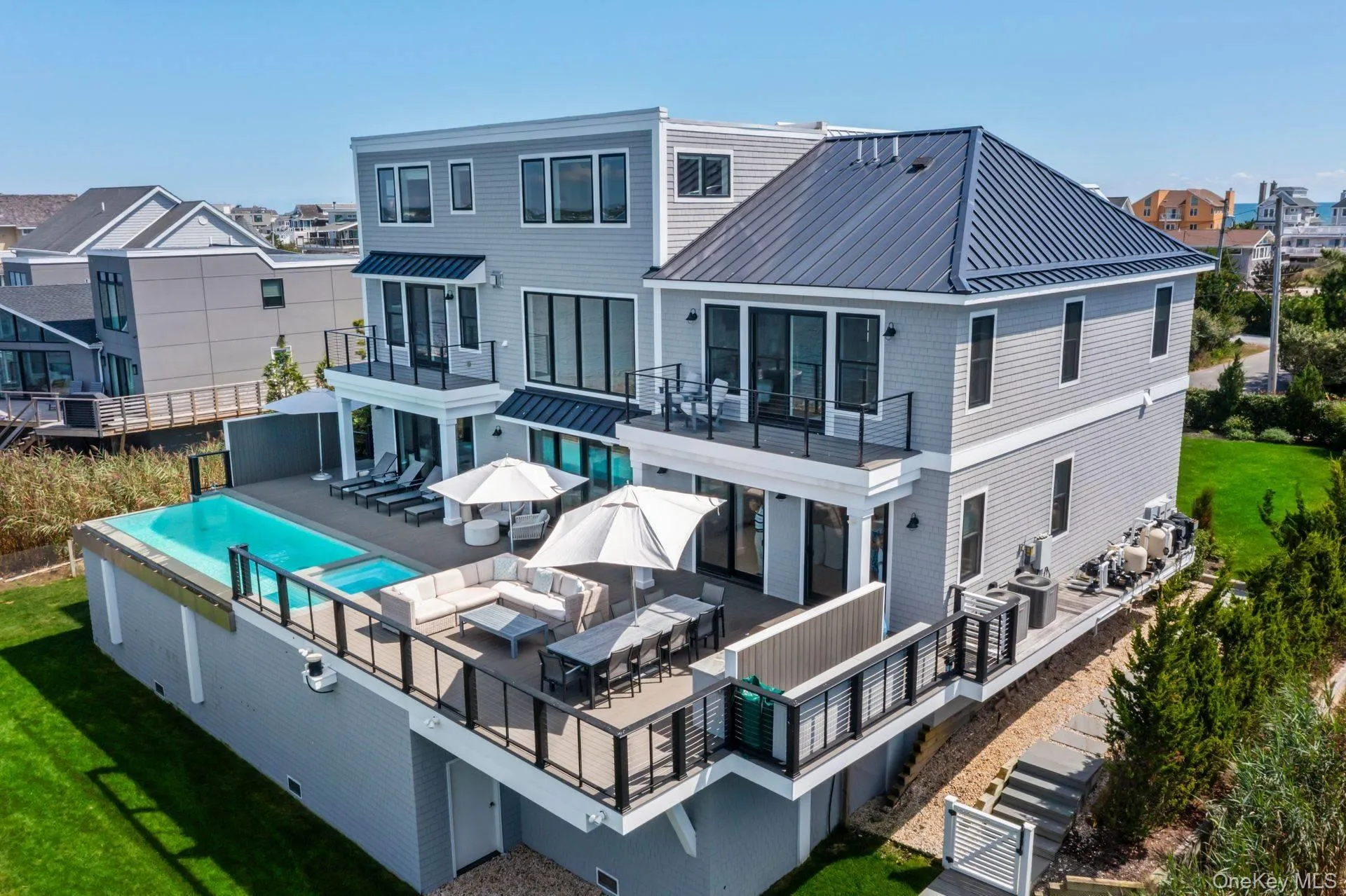 Rear view of property with a patio area, a balcony, and outdoor dining area Rear view of property with a patio area, a balcony, and outdoor dining area