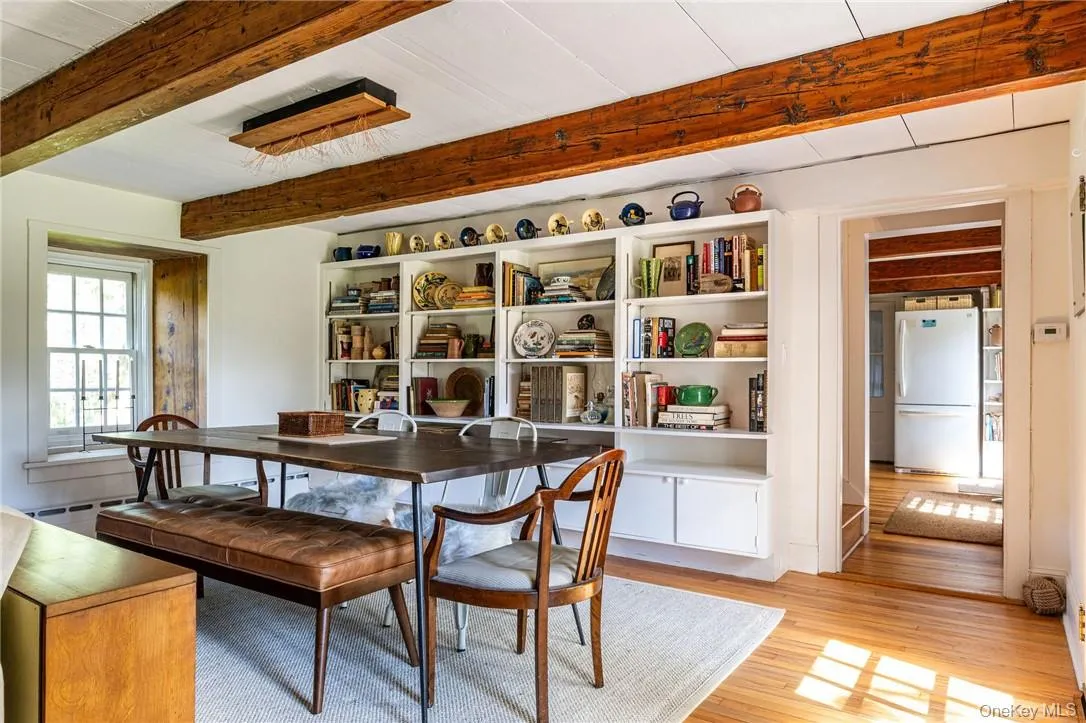 Dining area featuring beamed ceiling, wood floors Dining area featuring beamed ceiling, wood floors