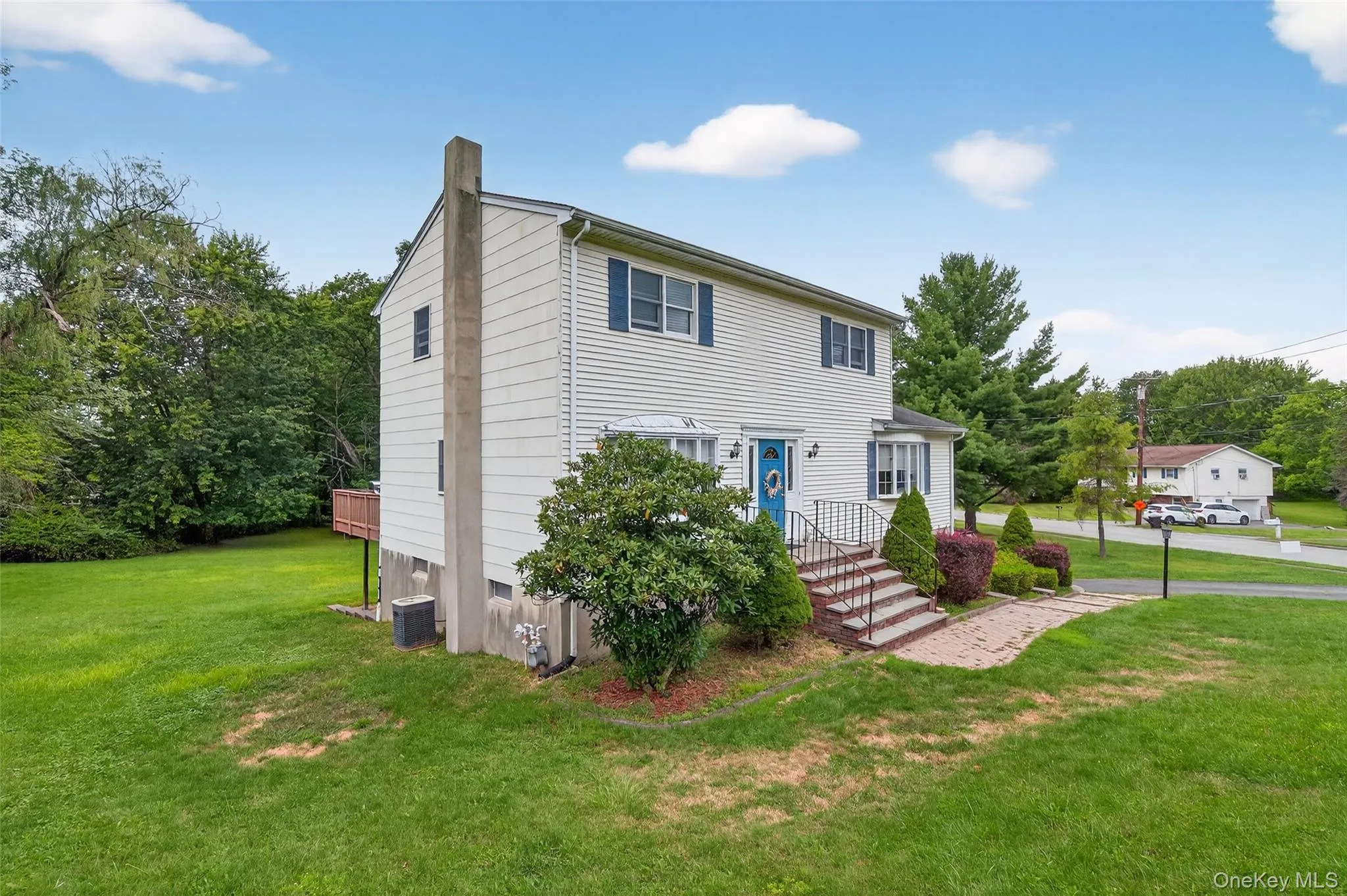 Colonial-style house with a front lawn Colonial-style house with a front lawn