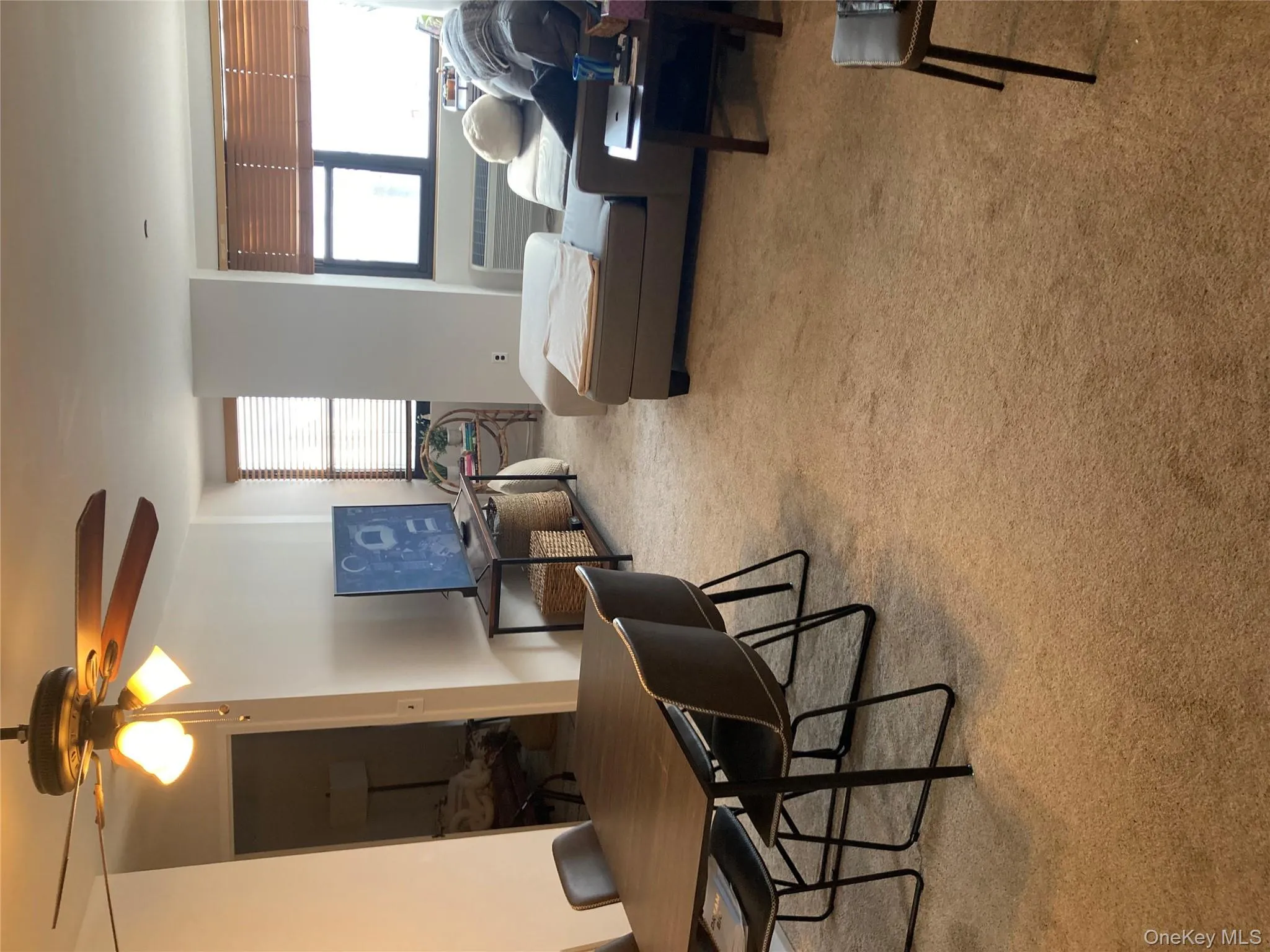 Dining room featuring light colored carpet and ceiling fan Dining room featuring light colored carpet and ceiling fan
