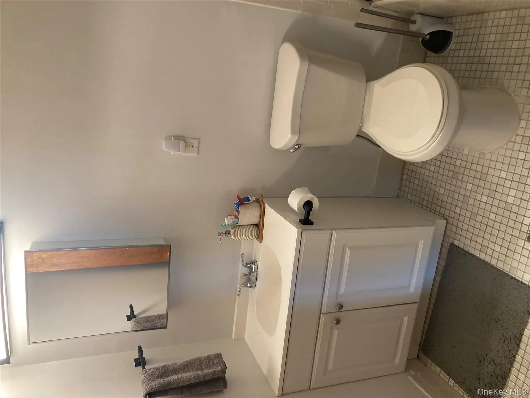 Bathroom featuring vanity and light tile patterned flooring Bathroom featuring vanity and light tile patterned flooring