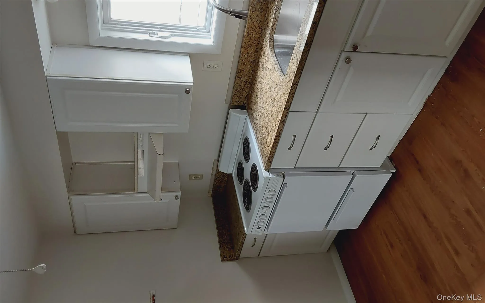 Kitchen with white cabinets, electric range, ventilation hood, and dark wood-style floors Kitchen with white cabinets, electric range, ventilation hood, and dark wood-style floors